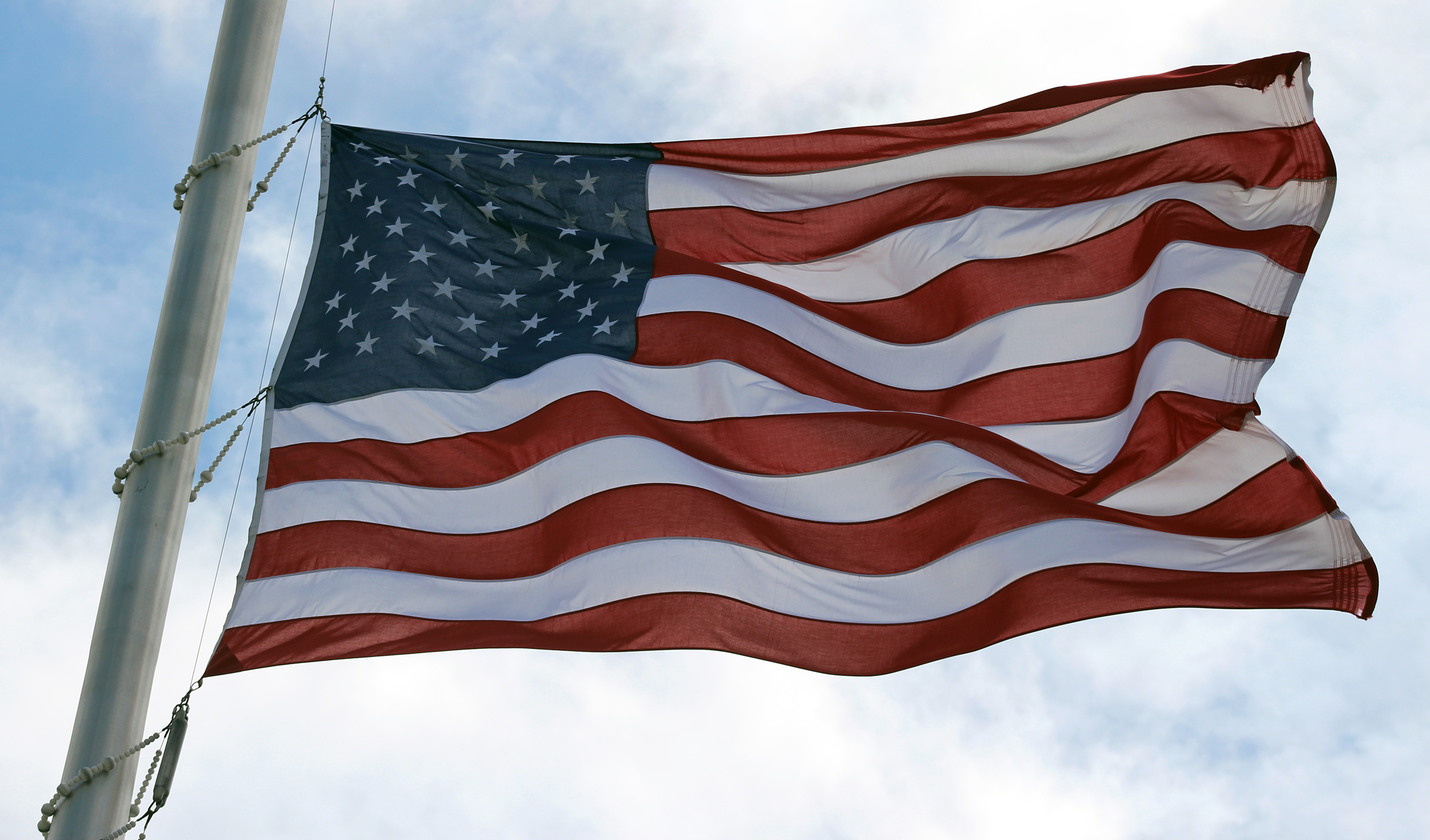 A flag waves at half-staff at Omaha National Cemetery near Papillion. (Photo by Scott Stewart)
