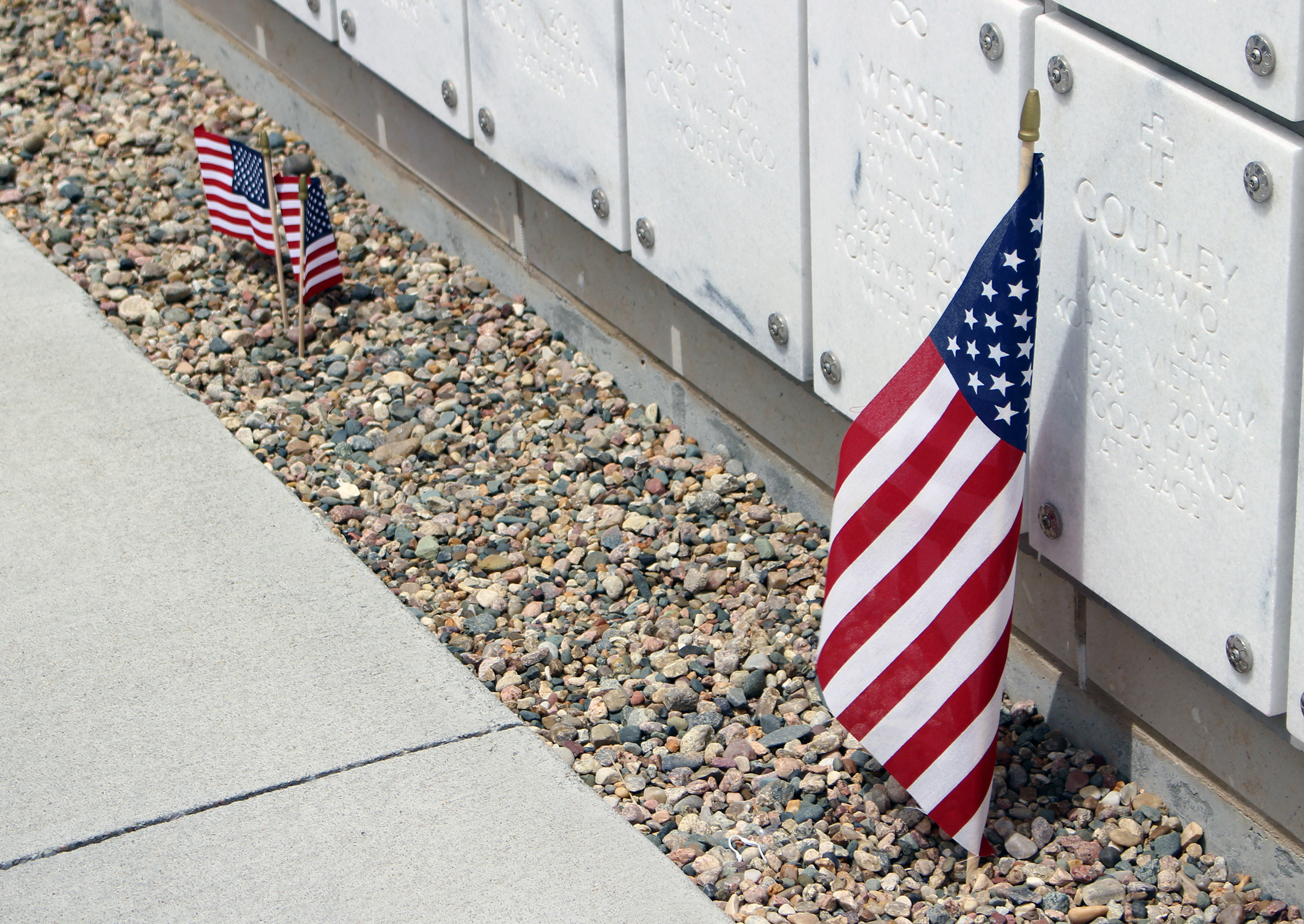 The families of fallen servicemembers had started leaving flowers by the graves of their loved ones at Omaha National Cemetery near Papillion in recognition of Memorial Day on Monday, May 25. (Photo by Scott Stewart)