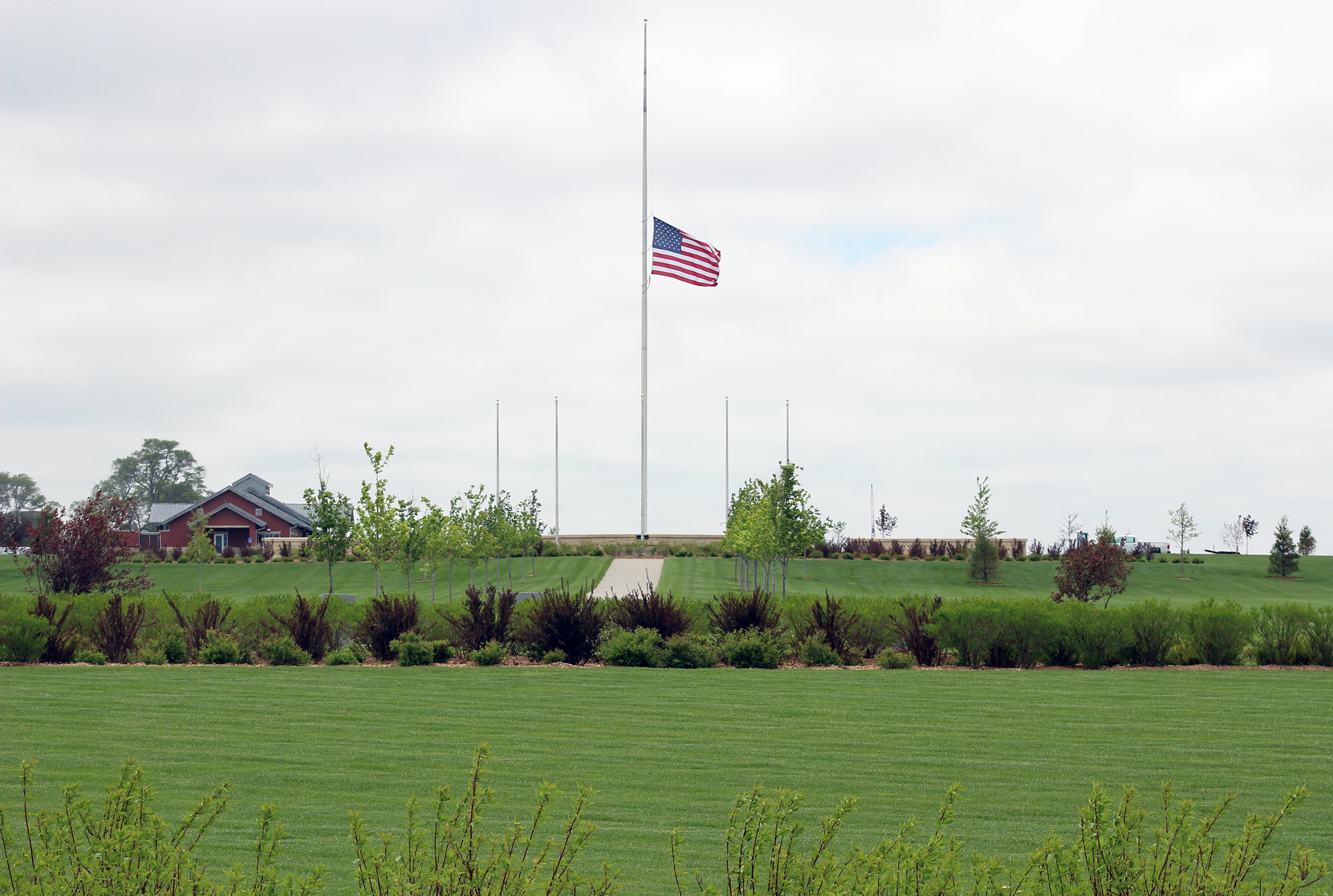 A flag waves at half staff at the Omaha National Cemetery outside Papillion on Wednesday, May 20, 2020. (Photo by Scott Stewart)