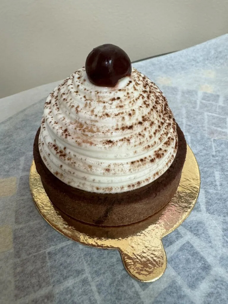 A dessert from 19th-century Paris, the Mont Blanc, is made with chestnut cream and a chocolate cookie base covered in whipped cream and topped with a cherry.<br />(Sarah Baker Hansen/ Flatwater Free Press)