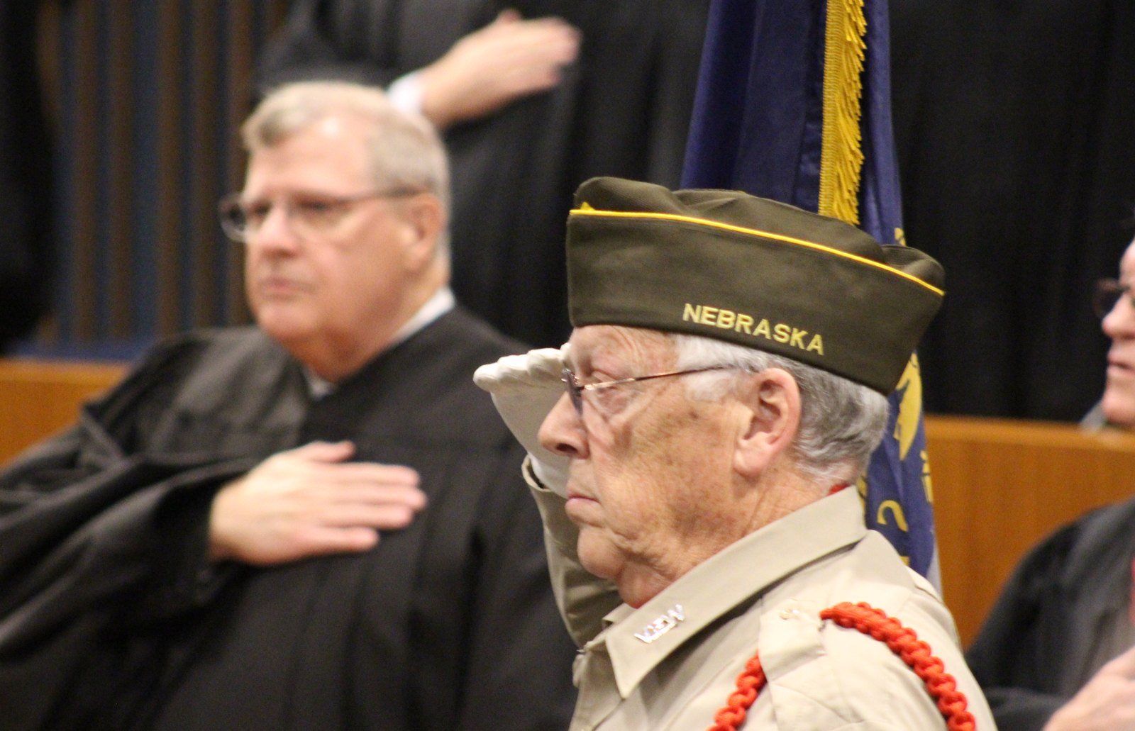 A member of the Benson VFW Post 2503 honor guard salutes the flag during the advancement of the colors at the OBA’s annual Memorial Day Program in the legislative chamber of the Omaha-Douglas Civic Center on May 10, 2019. (Photo by Scott Stewart)