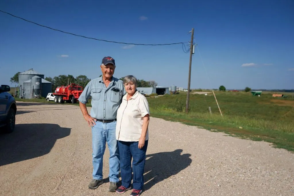 Jim and Carolyn Knopik stand in front of their house in Belgrade, Nebraska on Sept. 11, 2023.<br />(Yanqi Xu / Flatwater Free Press)