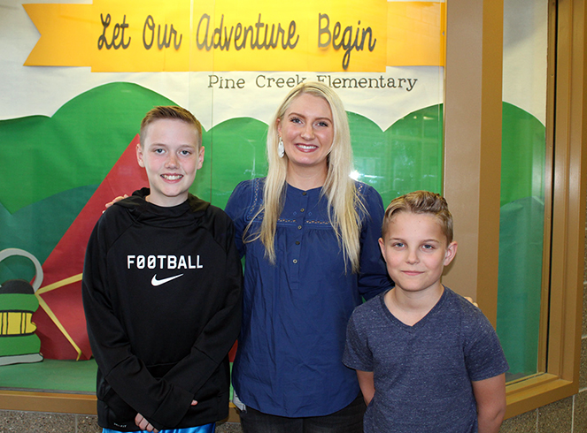 Fifth grade teacher Kathleen Cannon (center) once again had two students earn awards in the Law Day poster contest. Here she poses with second-place winner Noah Hall (left) and third-place winner Caden Ritonya, both students at Pine Creek Elementary School in Bennington. (Photo by Lorraine Boyd)