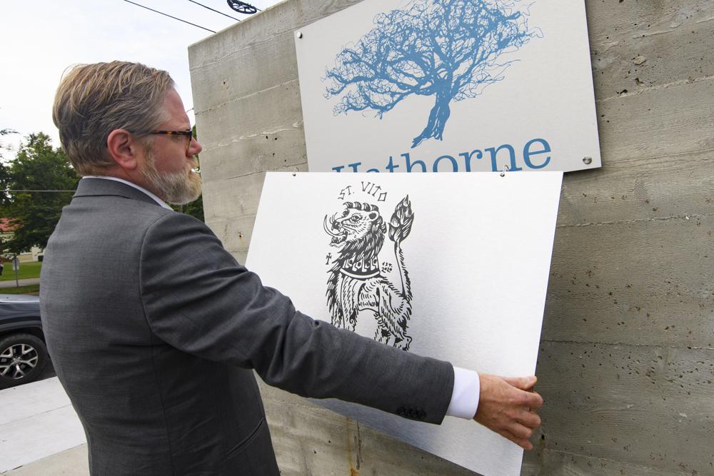 John Stephenson holds a sign for a pop-up restaurant, Wednesday, Aug. 18, 2021, in Nashville, Tenn. (AP)