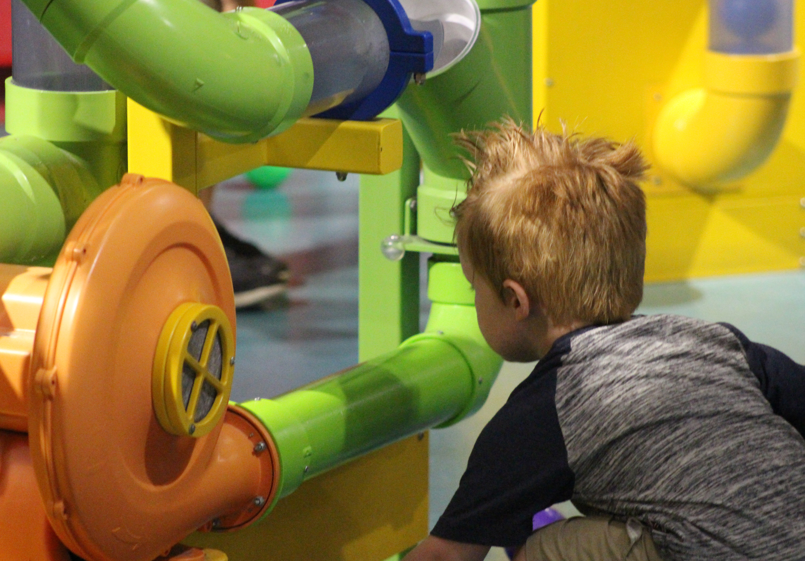 A child plays with a series of tubes at the Omaha Children’s Museum during the 10th annual Summer Family Reunification Picnic on June 7, 2019. (Photo by Scott Stewart)