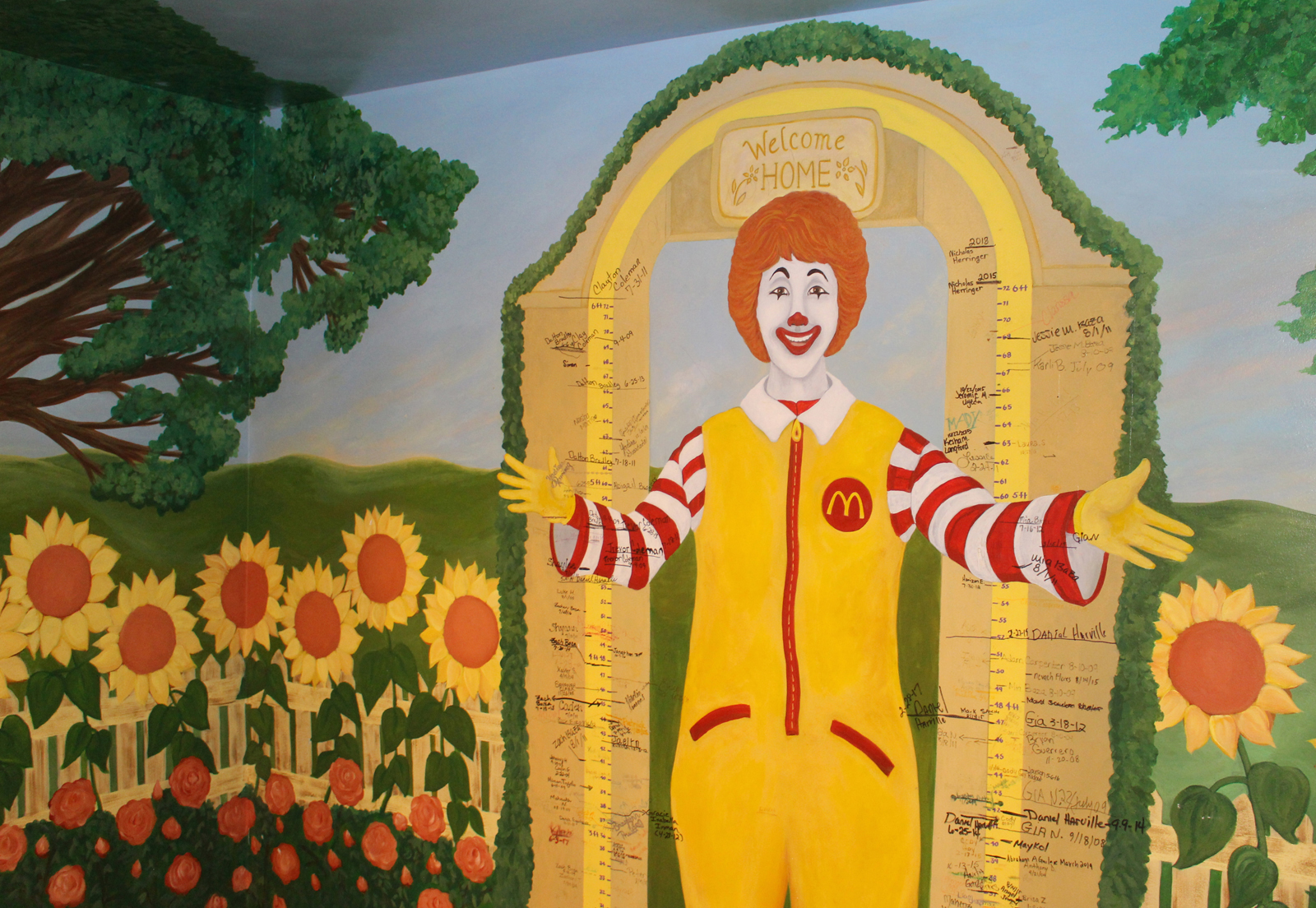 A mural of Ronald McDonald shows the height of children who have stayed at the Ronald McDonald House, 620 S. 38th Ave., charting how they have grown during their recovery. The mural was on display to the public during an open house Saturday, May 11, 2019. (Photo by Scott Stewart)