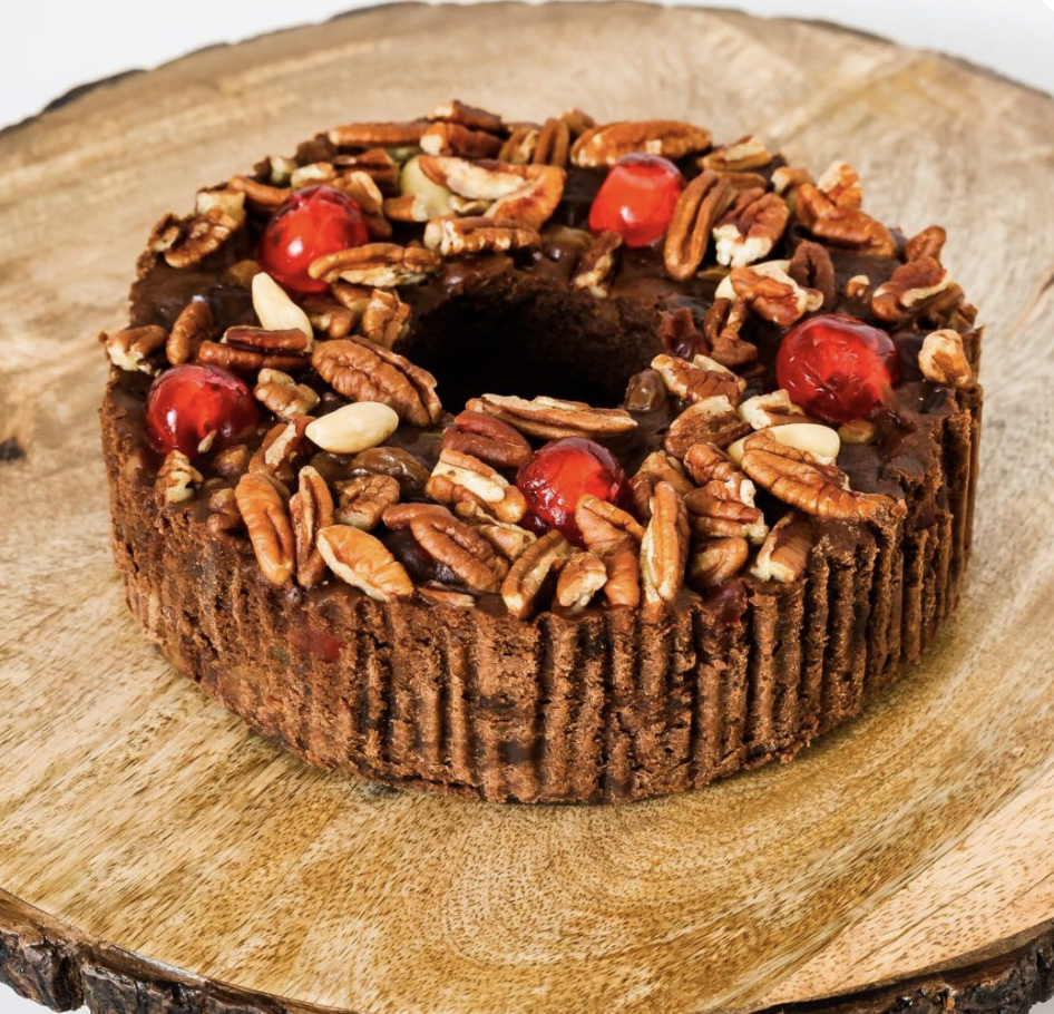 Beatrice Bakery’s employees hand-decorate each cake. They sort all the fruits and nuts used in the cakes - like cherries and pecans - eyeballing each piece of fruit personally to check for pits and ripeness. (Courtesy of Beatrice Bakery)