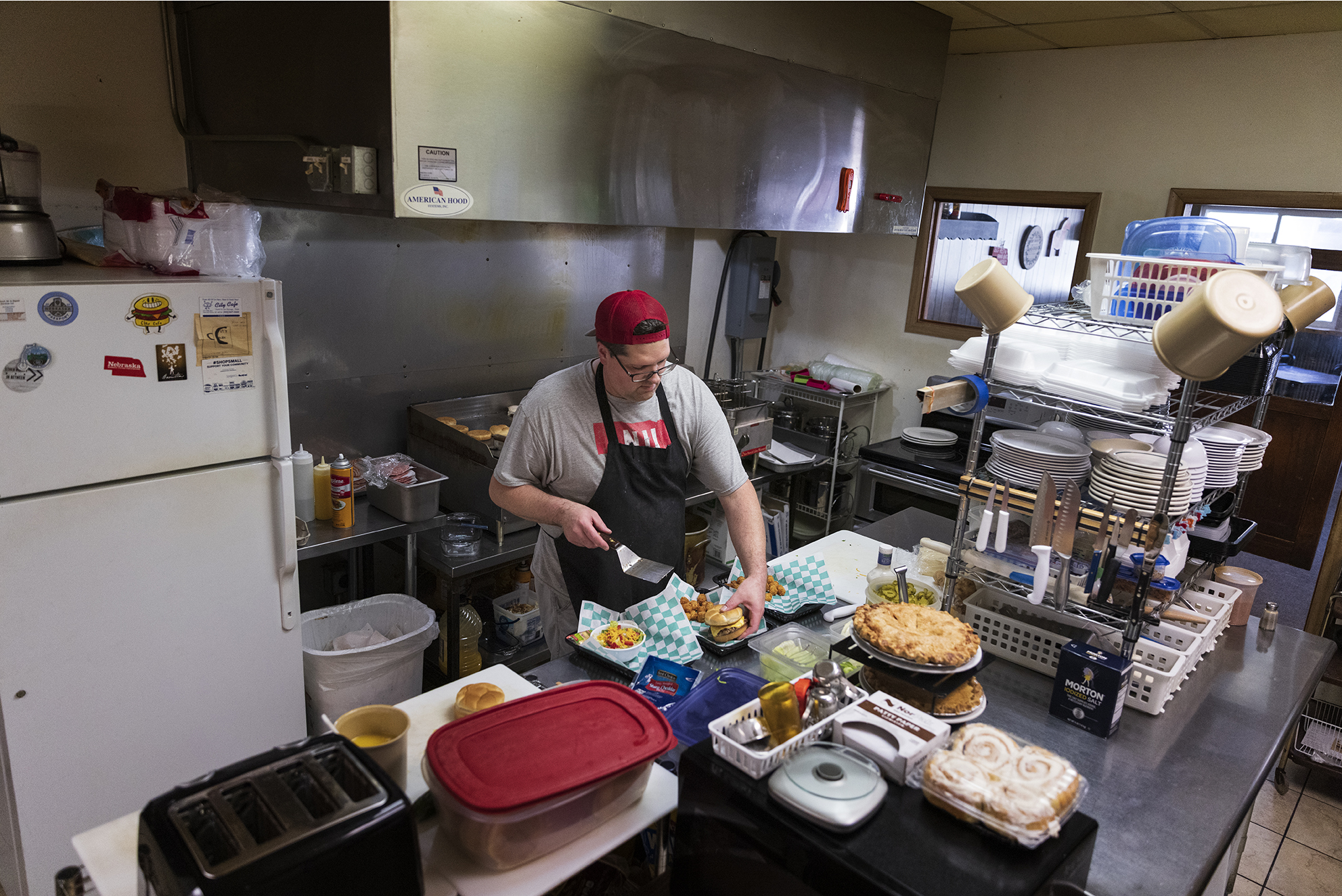 Owner Adam Witchell plates a lunch order in the City Cafe’s kitchen. The City Cafe is a staple of Newman Grove’s downtown business district. The cafe is seen here on Saturday, Aug. 28, 2021, in Newman Grove. (Ryan Soderlin / Flatwater Free Press)