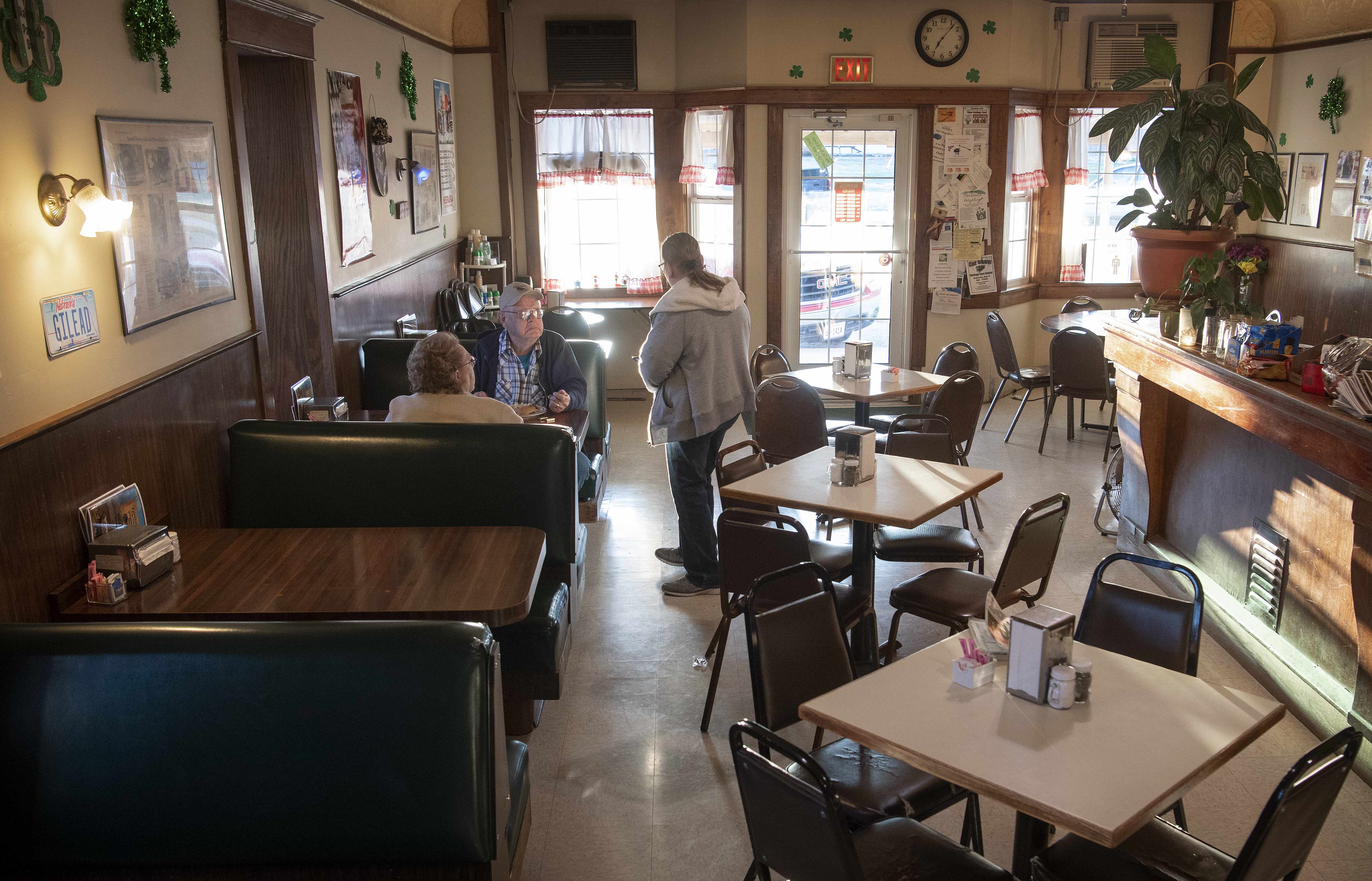 Don and Rita Richardson celebrate Don’s 80th birthday as they talk to owner Karen Keilwitz, right, Friday, March 20, 2020, at the Pioneers Inn restaurant in Gilead. Nine months ago, Keilwitz didn’t know how long she could keep feeding her town. The owner of the Pioneers Inn was trying to make sense of what the earliest coronavirus-related restrictions would mean to Gilead’s only restaurant. (Francis Gardler/Lincoln Journal Star via AP)