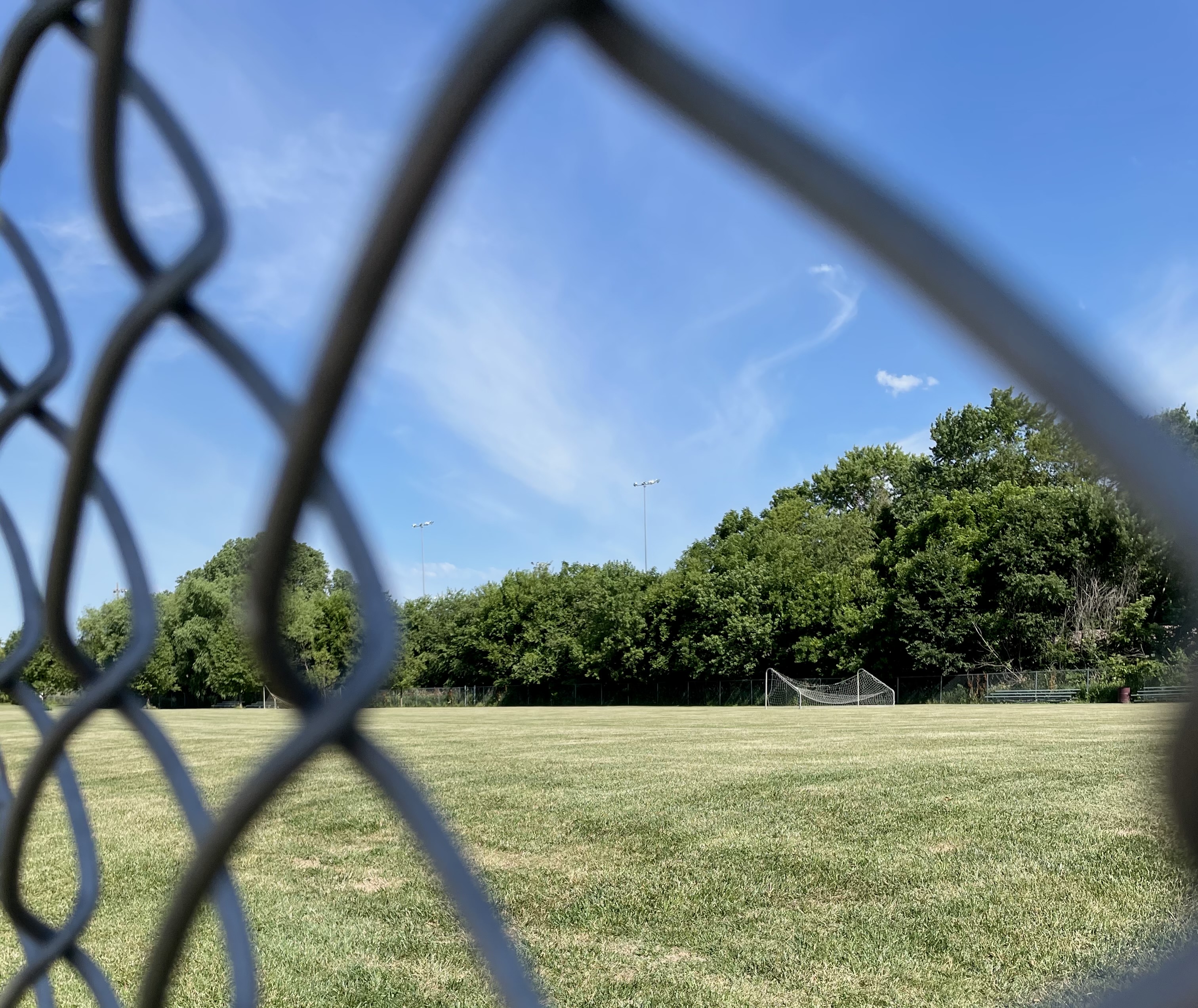 The city-owned soccer fields on Serum Road are being sold to a developer to be transformed into storage units. The fields are shown through a chain link fence Tuesday, June 22, 2021. (Molly Ashford/Daily Record)