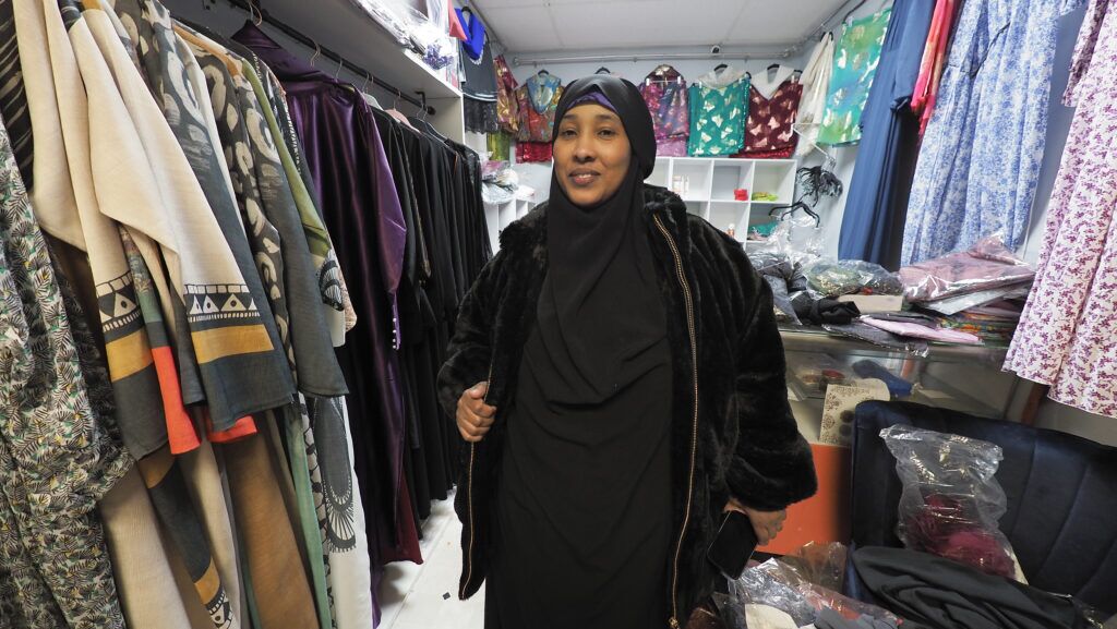 Halima Ali talks about her various offerings to patrons in her shop on Dakota Avenue in South Sioux City. Ali has lived in South Sioux City for 11 years. Next year, her mother will join her from Uganda.<br />(Jerry L Mennenga / Flatwater Free Press)