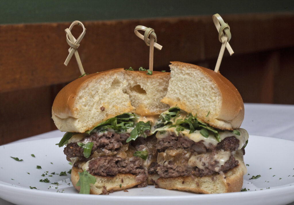 Because diners have a tough time choosing between The Speakeasy’s burger or a steak, chef Ryan Puls added a burger cut into four wedges to the restaurant’s appetizer menu.<br />(Laura Beahm / Flatwater Free Press)