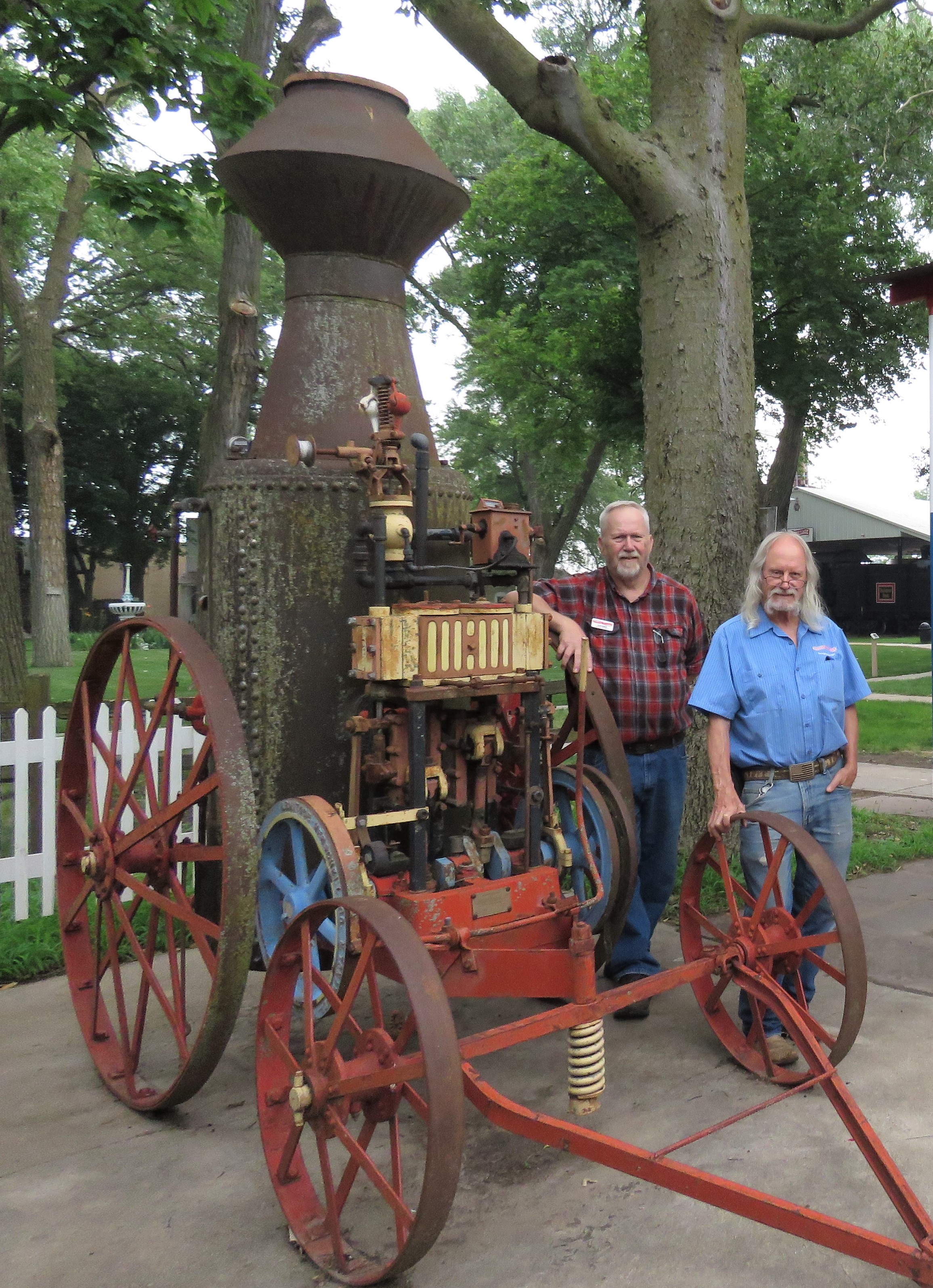 The original steam engine won&#039;t run the now electric-powered Pioneer Village carousel, but former and current carousel operators Al Farlin (left) and Brad Roberts hope to see it restored to use in steam power demonstrations.<br />(Lori Potter / Flatwater Free Press)