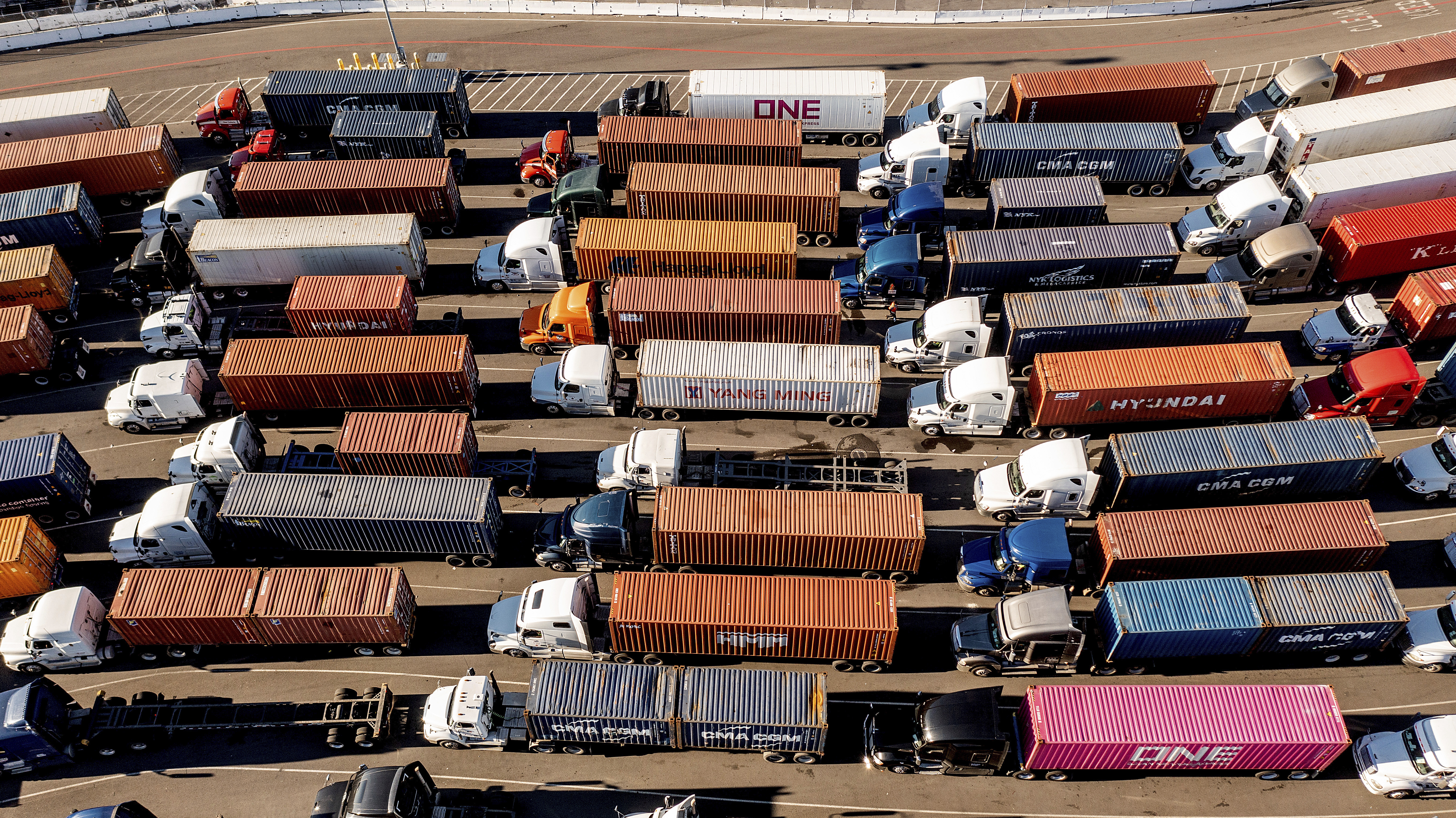 Trucks line up to enter a Port of Oakland shipping terminal on Wednesday, Nov. 10, 2021, in Oakland, Calif. Intense demand for products has led to a backlog of container ships outside shipping ports. (AP)