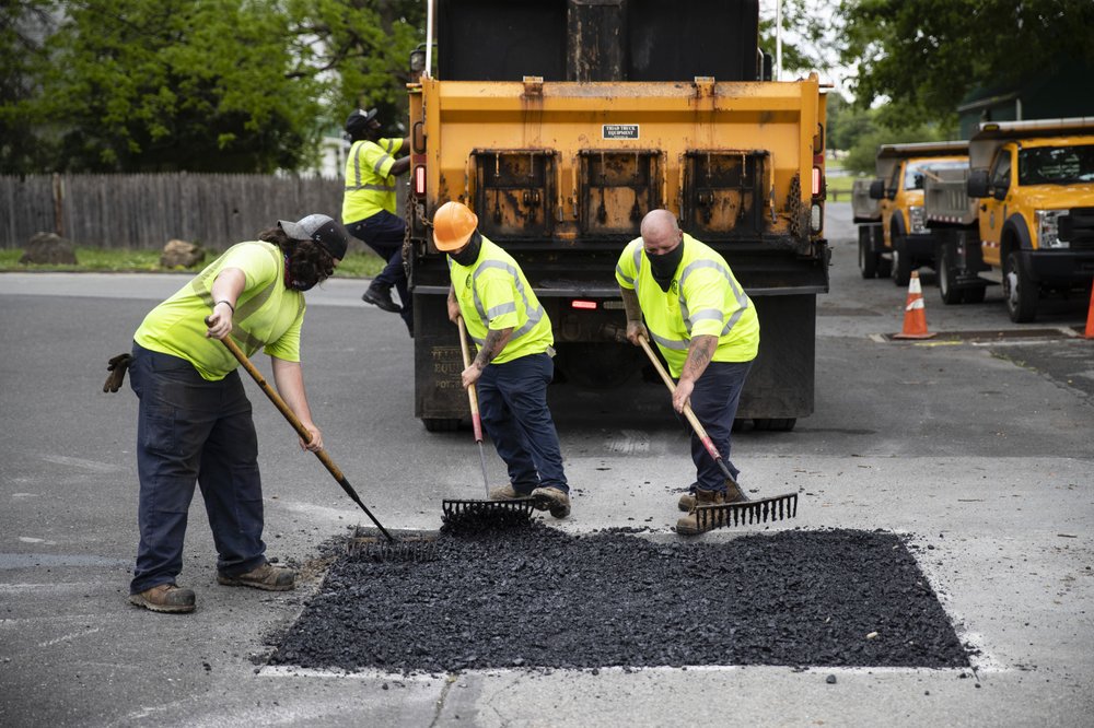 Employees of the Allentown, Pa., streets department patch a hole near Jordan Park in Allentown, Pa., Friday, May 29, 2020. Unfilled potholes, uncollected trash, unmowed grass and, most significantly, fewer police on the street are some of what Allentown says it’s contemplating unless Washington helps it plug a multimillion-dollar budget hole left by the coronavirus pandemic. (AP)