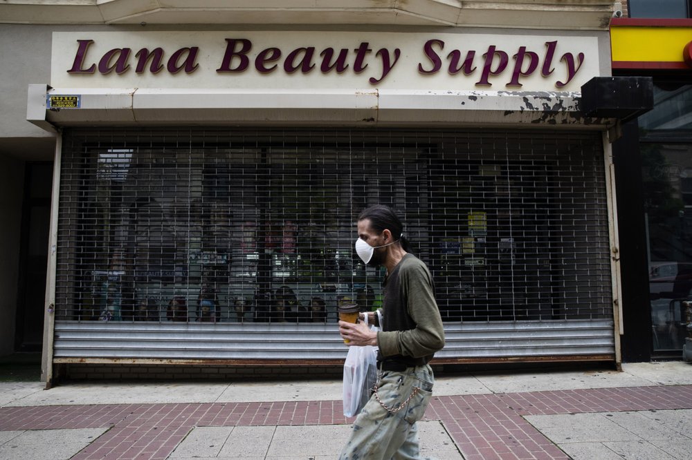 A shopper in a mask walks in front of a shuttered store in downtown Allentown, Pa., Friday, May 29, 2020. Left out of the $2 trillion coronavirus relief package passed by Congress in late March, Allentown and thousands of other smaller cities and counties across the United States have largely fended for themselves amid sharply falling tax revenues. (AP)