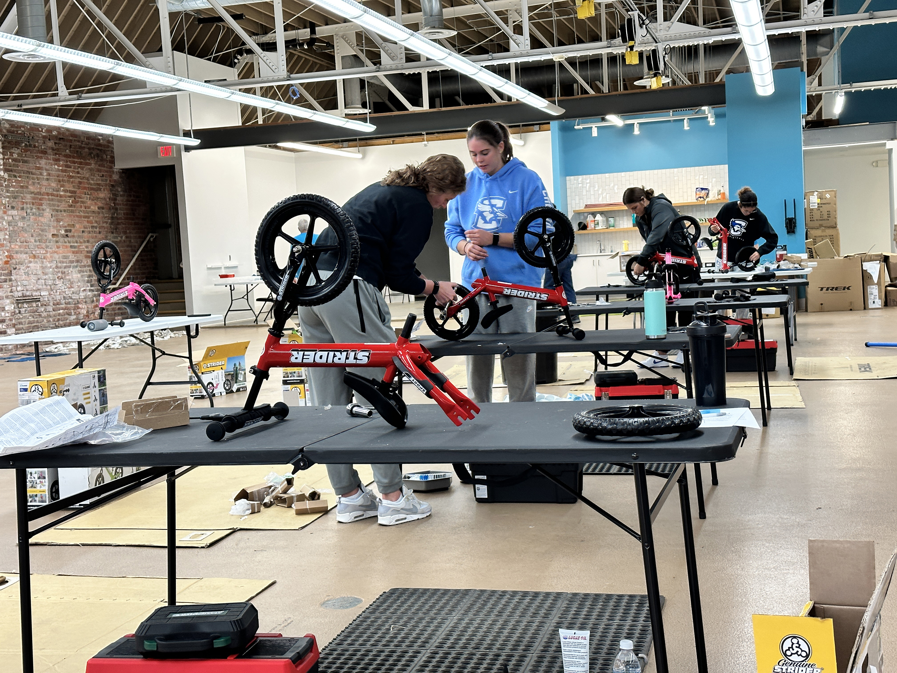 Volunteers working on cleaning and fixing the bikes. The public donates gently used bikes to FB4K, a local nonprofit which organizes volunteers to clean and refurbish them, and then give them away to youth-serving, nonprofits and other organizations.<br />(Free Bikes 4 Kidz)