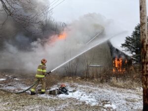 Several homes have been burned down and buried in Winslow after owners took a federal buyout to make their lots permanent green spaces. Only about 15 homes remain in a town that recently had 140 residents.<br />(Paul Hammel / Nebraska Examiner)