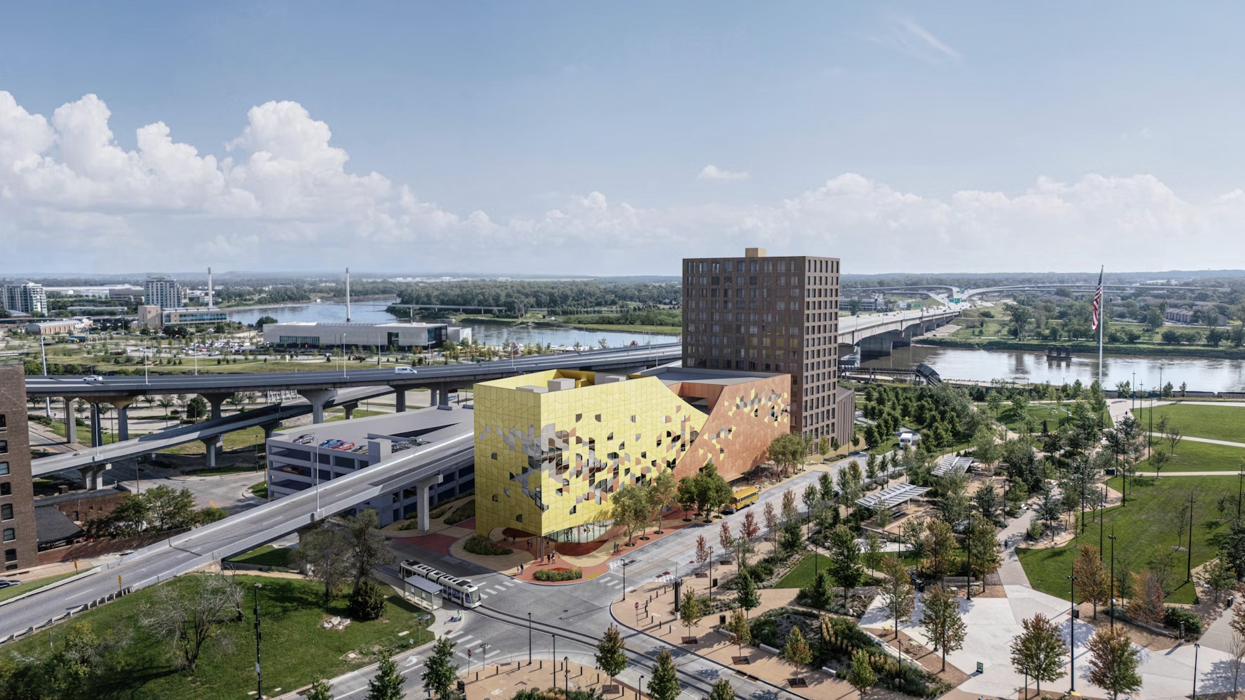 Planned Omaha Children’s Museum shown in the colorful yellow and orange, next to the high-rise apartments by NuStyle Development. The projects would rise downtown north of the Heartland of America’s Park at The Riverfront.<br />(Courtesy of Snøhetta and Tegmark)