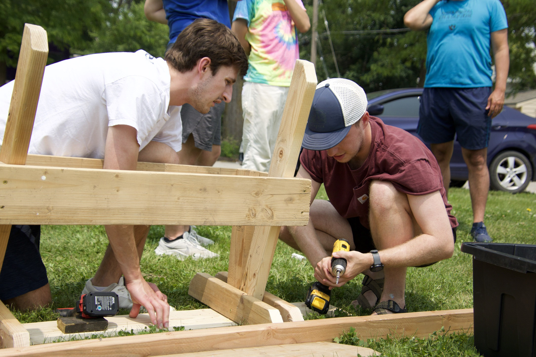 Jack Cicin (left) and Jared Haynes build a wooden bench during a Strong Towns gathering in North Omaha on June 1. The group later placed the benches at bus stops that lacked seating.<br />(Jeremy Turley / Flatwater Free Press)