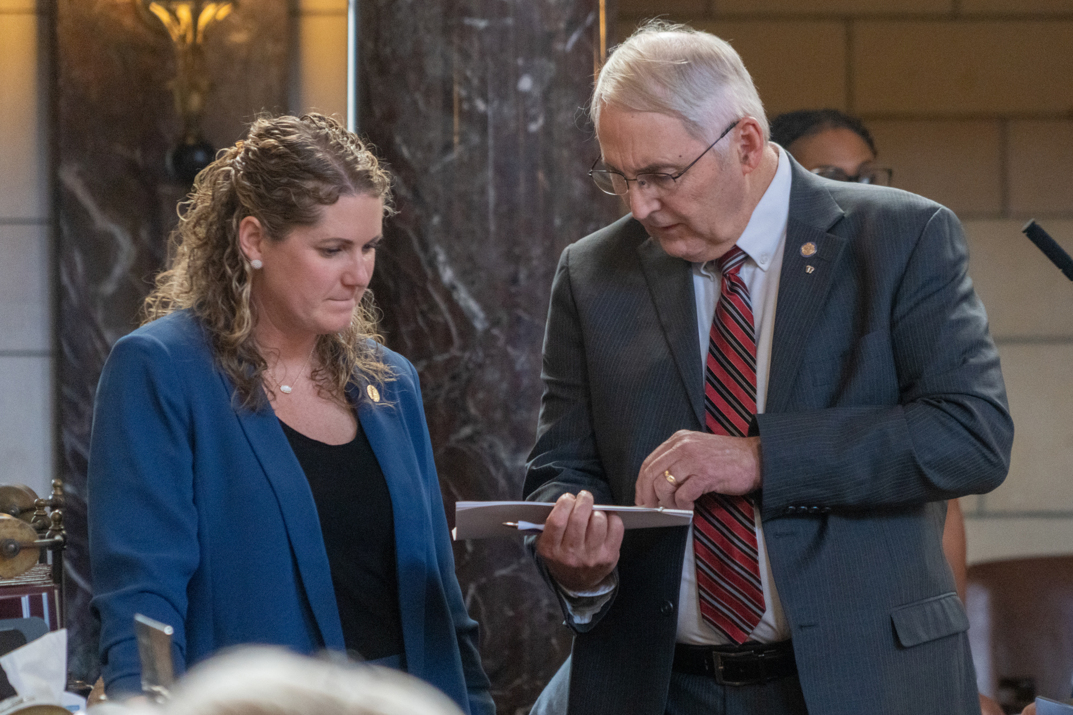 State Sen. Rob Clements of Elmwood (right)talks with State Sen. Carolyn Bosn of Lincoln on the floor of the Nebraska Legislature on Feb. 27, 2024.<br />(Zach Wendling / Nebraska Examiner)