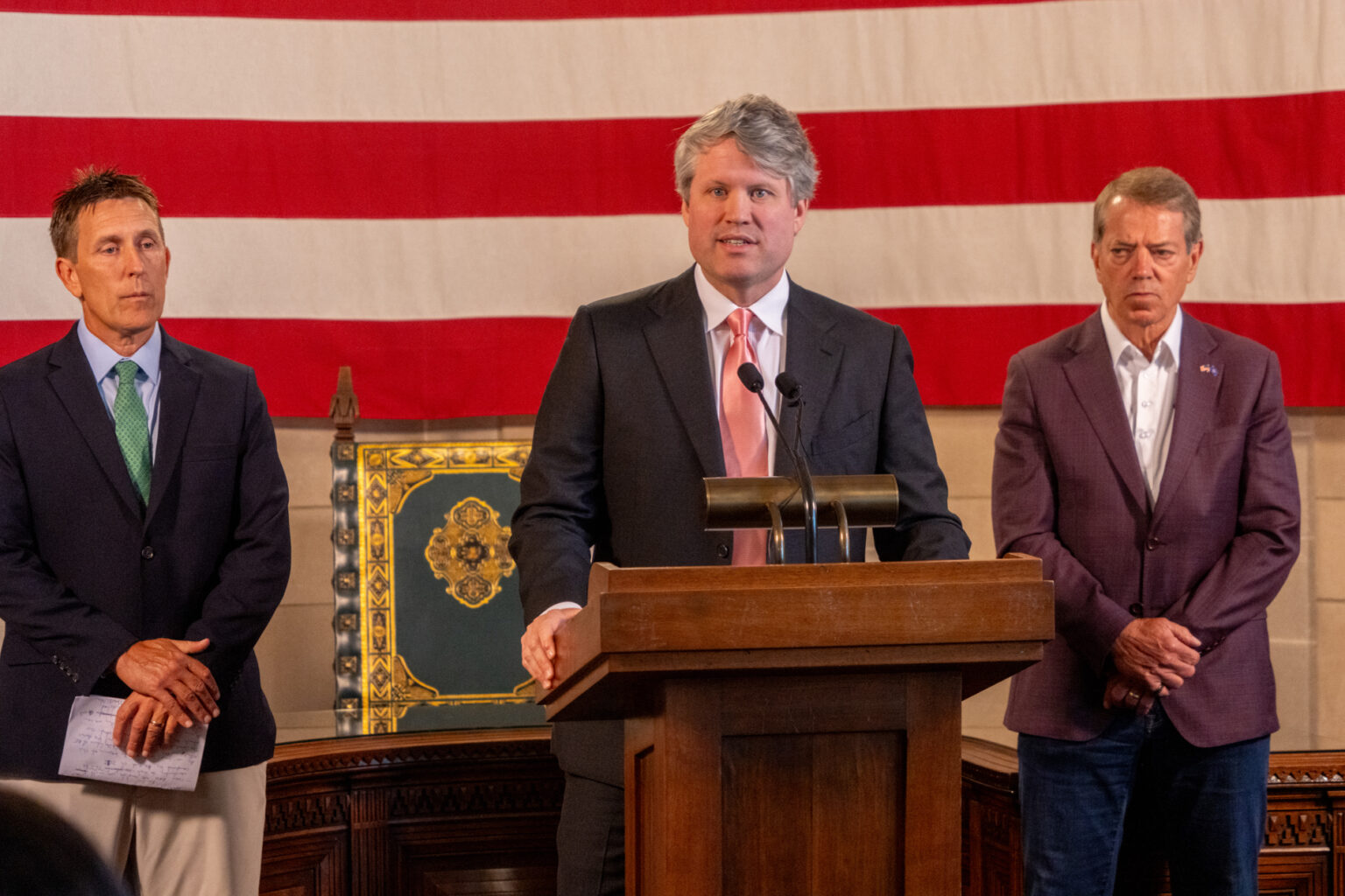 Nebraska Attorney General Mike Hilgers (center) and Gov. Jim Pillen (right) announce a lawsuit against Colorado before the U.S. Supreme Court seeking to assert Nebraska’s water rights to the South Platte River that crosses state lines. At left is Jesse Bradley, director of the Nebraska Department of Water, Energy and Environment, July 16, 2025.<br />(Zach Wendling / Nebraska Examiner)