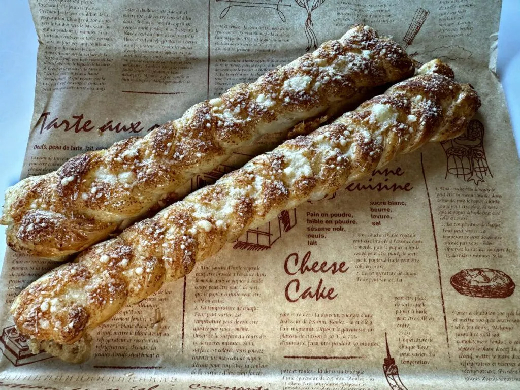 Braided croissant dough is topped with fresh Parmigiano-Reggiano cheese, making for a crisp-tender, savory treat.<br />(Sarah Baker Hansen / Flatwater Free Press)