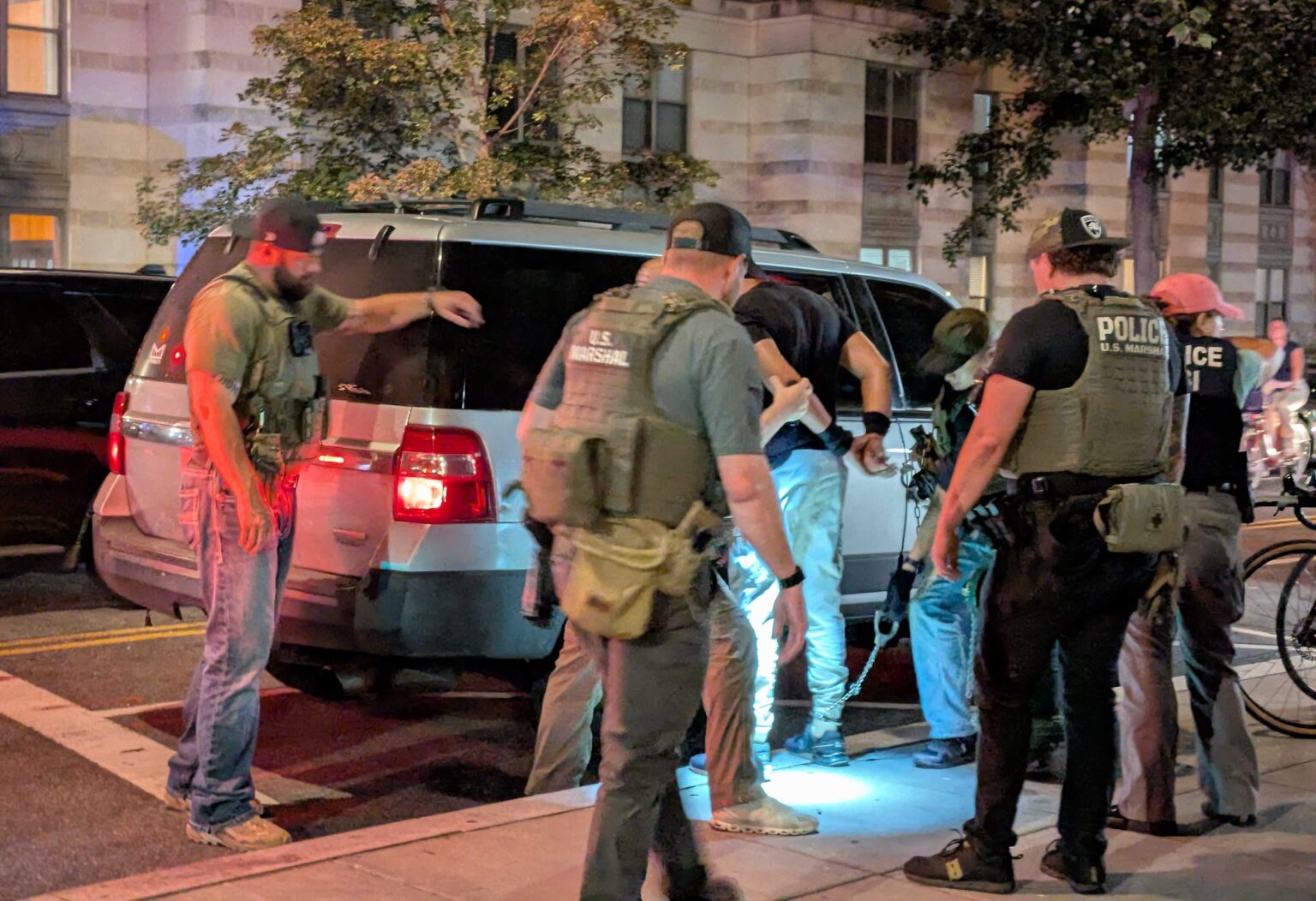 U.S. Marshals and Homeland Security Investigations agents take a man into custody at the intersection of 14th and N streets NW in Washington, D.C., on Sept. 3, 2025.<br />(Ashley Murray / States Newsroom)