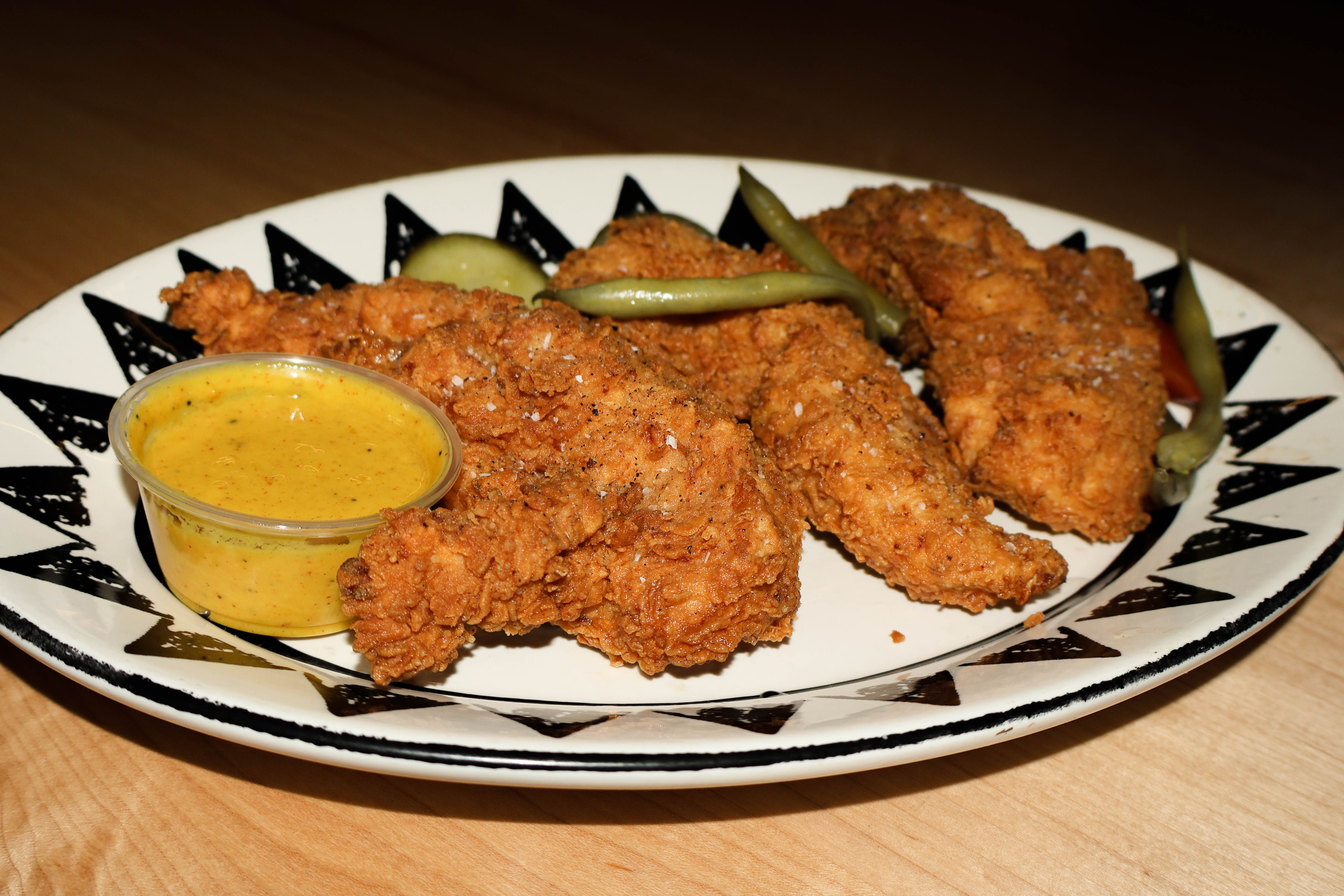 Pictured is the Sweet Tea Brined White Meat Tenders served with scratch pickles and chipotle honey mustard.  (Josie Charron / The Daily Record)