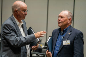 State Sens. Myron Dorn of Adams (left) and Tom Brandt of Plymouth talk at a legislative retreat in Kearney on Friday, Dec. 13, 2024.<br />(Zach Wendling / Nebraska Examiner)