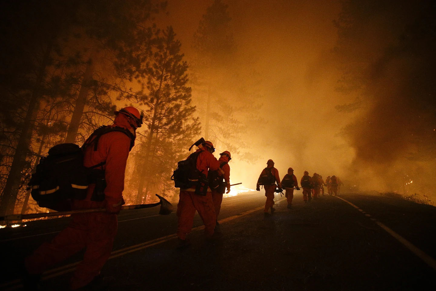 Inmate firefighters walk along Highway 120 after a burnout operation during the Rim Fire near Yosemite National Park, Calif., Aug. 25, 2013.<br />(Jae C. Hong / AP Photo)