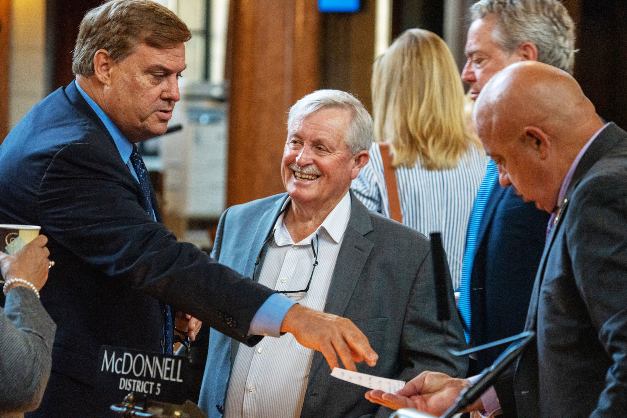 State Sen. Steve Erdman of Bayard (center). To his right, State Sen. Mike McDonnell of Omaha reaches out to State Sen. Tom Brewer of north-central Nebraska, July 30, 2024.<br />(Zach Wendling / Nebraska Examiner)