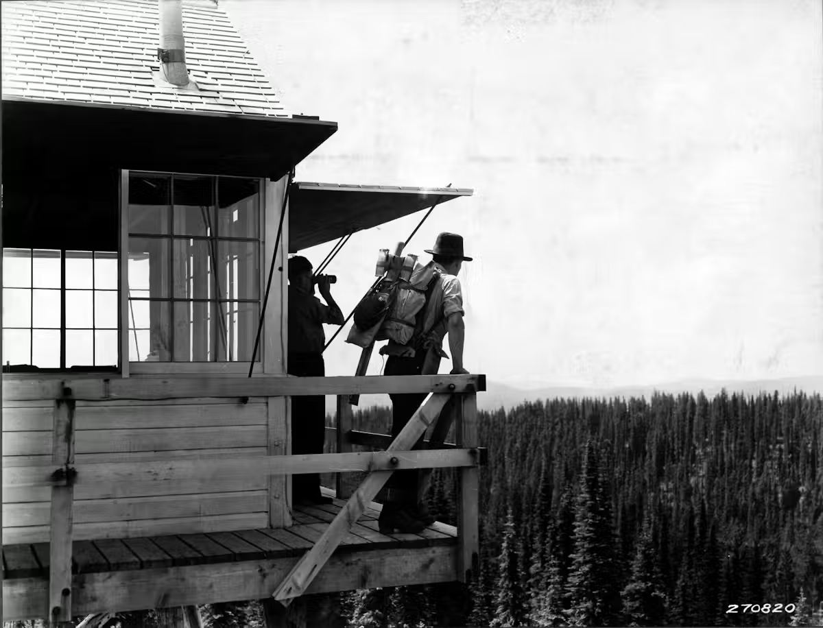 Firefighters keep watch for smoke from a fire tower in the Coeur d&#039;Alene National Forest, Idaho, in 1932.<br />(K. D. Swan / Forest Service)