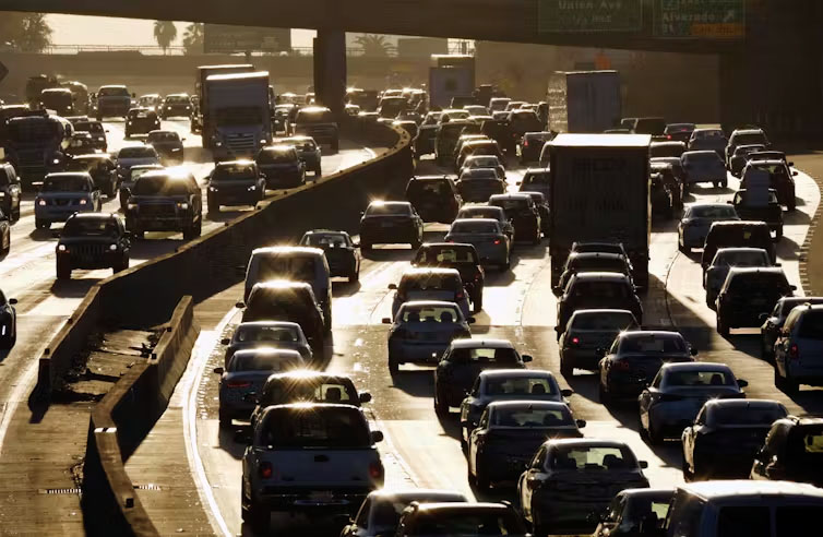 Cities like Los Angeles are expensive to live in, forcing people to move to the suburbs, which causes more traffic and greenhouse gas emissions.<br />(Richard Vogel / AP Photo)