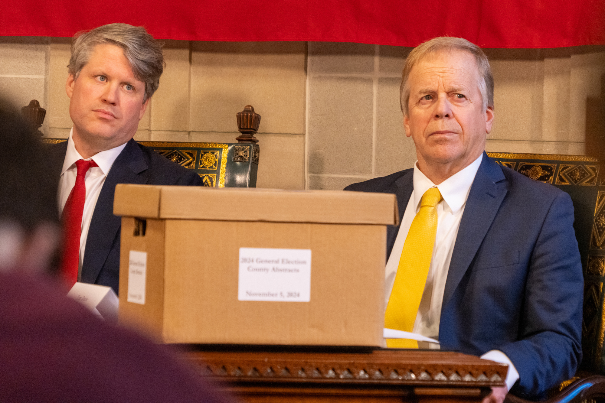 State Treasurer Tom Briese (right) and Nebraska Attorney General Mike Hilgers listen to testimony on the November 2024 general election before voting to certify the election results, Dec. 2, 2024.<br />(Zach Wendling / Nebraska Examiner)