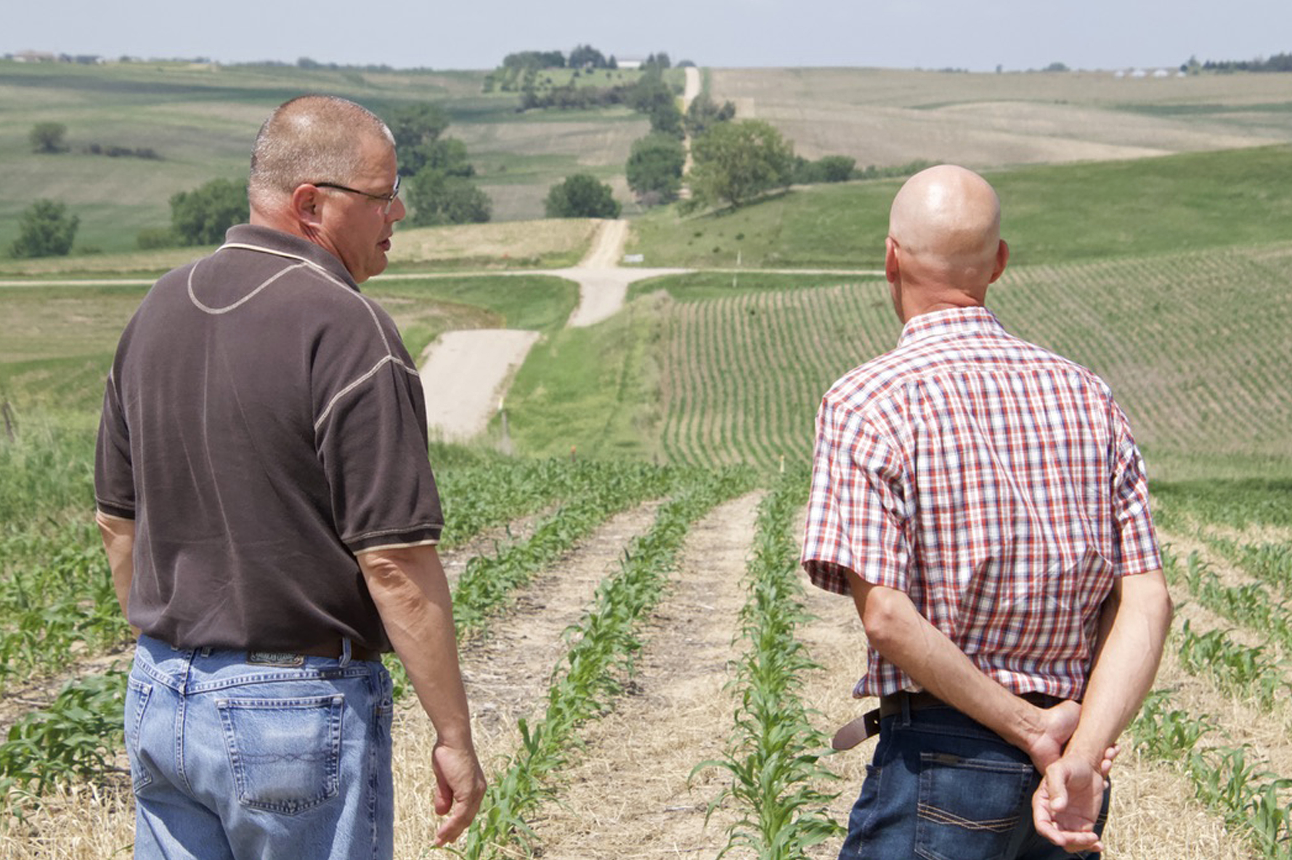 Stanton County landowner Justin Kennedy (left) speaks with a court-appointed appraiser as they look over land where the Nebraska Public Power District is taking an easement by eminent domain for a new transmission line. Kennedy said he hoped to build a home on the land someday, but those plans are now extinguished.<br />(Jeremy Turley / Flatwater Free Press)