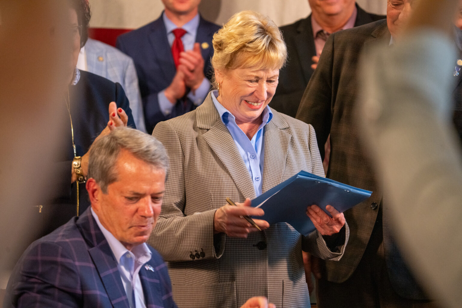 State Sen. Lou Ann Linehan of Elkhorn smiles at the newly signed Legislative Bill 34, the culmination of her eight years in the Legislature to address tax relief and six as chair of the Revenue Committee, Aug. 20, 2024.<br />(Zach Wendling / Nebraska Examiner)