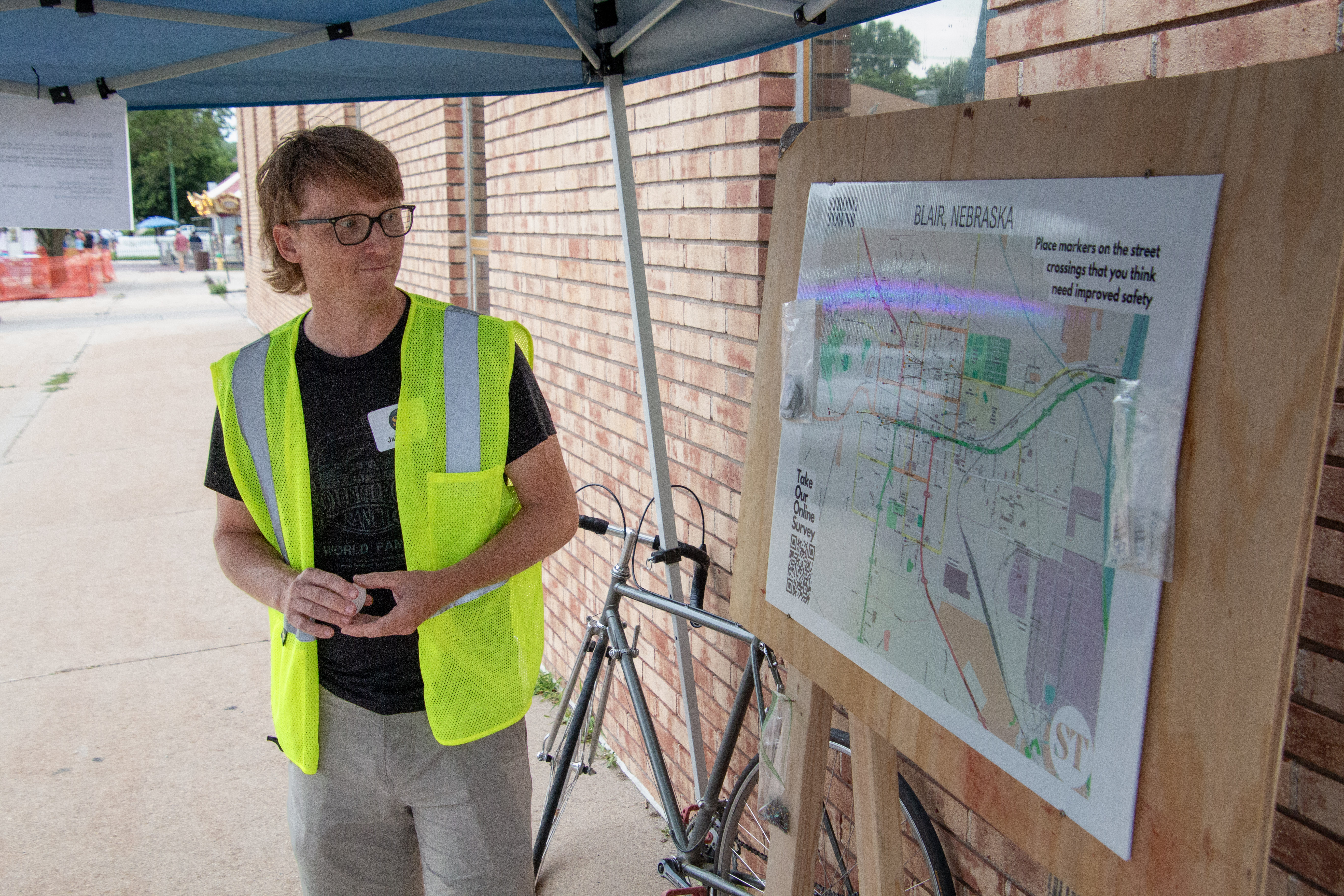 Strong Towns Blair founder Jake Loftis looks over a map of the city where survey respondents marked intersections in need of safety improvements. The public feedback gathered in June 2024 formed the basis of the group’s pitch to the City Council.<br />(Jeremy Turley / Flatwater Free Press)