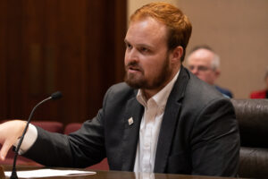 Edison McDonald with The Arc of Nebraska testifies before the Government, Military and Veterans Affairs Committee. (Zach Wending / Nebraska Examiner)