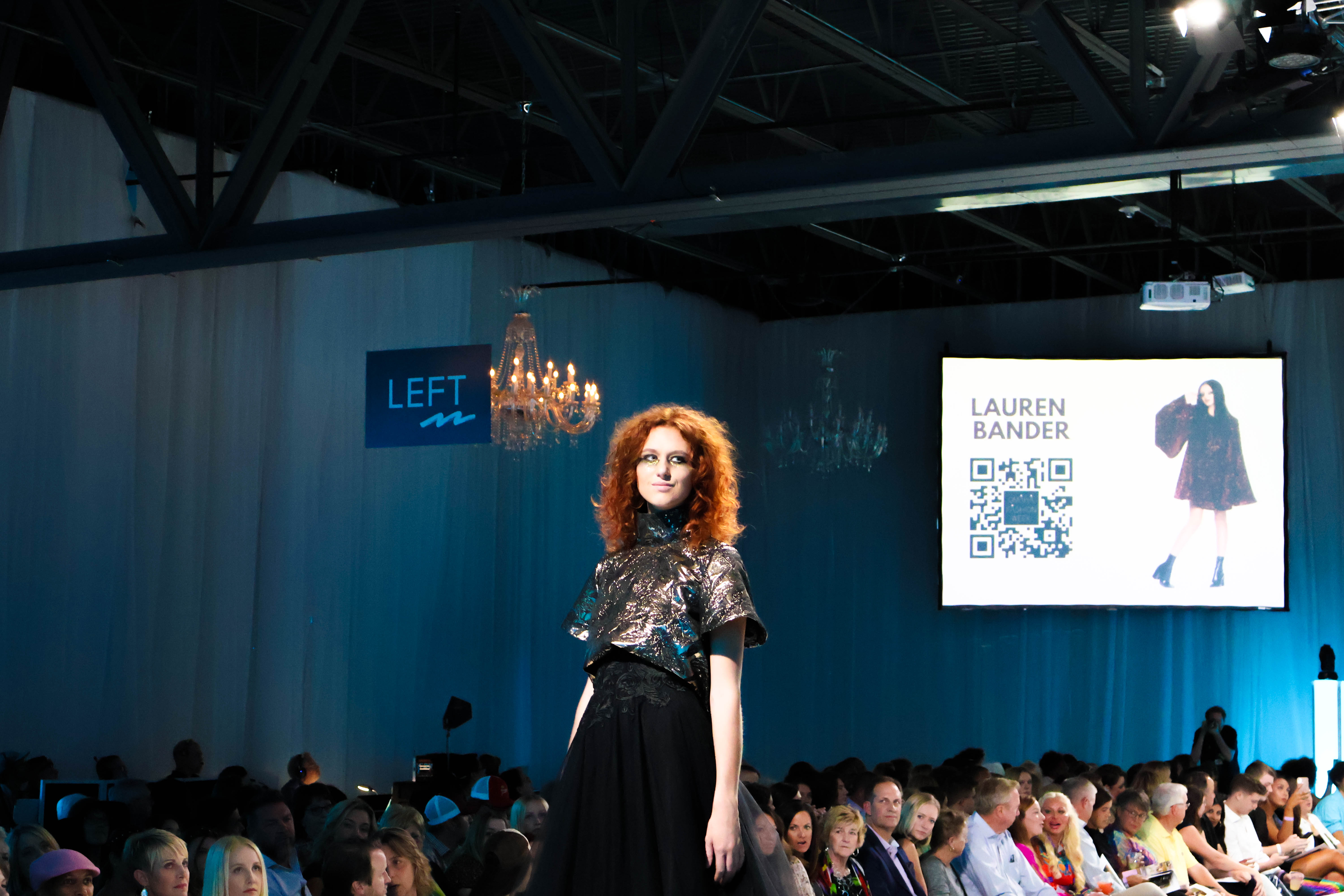 A model poses at the end of the runway wearing headliner Lauren Bander’s collection. (Josie Charron / The Daily Record)