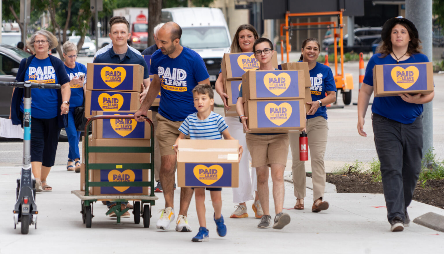 Advocates for a minimum degree of paid sick leave for Nebraska workers brought boxes of petition signatures to downtown Lincoln before bringing them to the Nebraska Secretary of State’s Office on June 27, 2024.<br />(Zach Wendling / Nebraska Examiner)