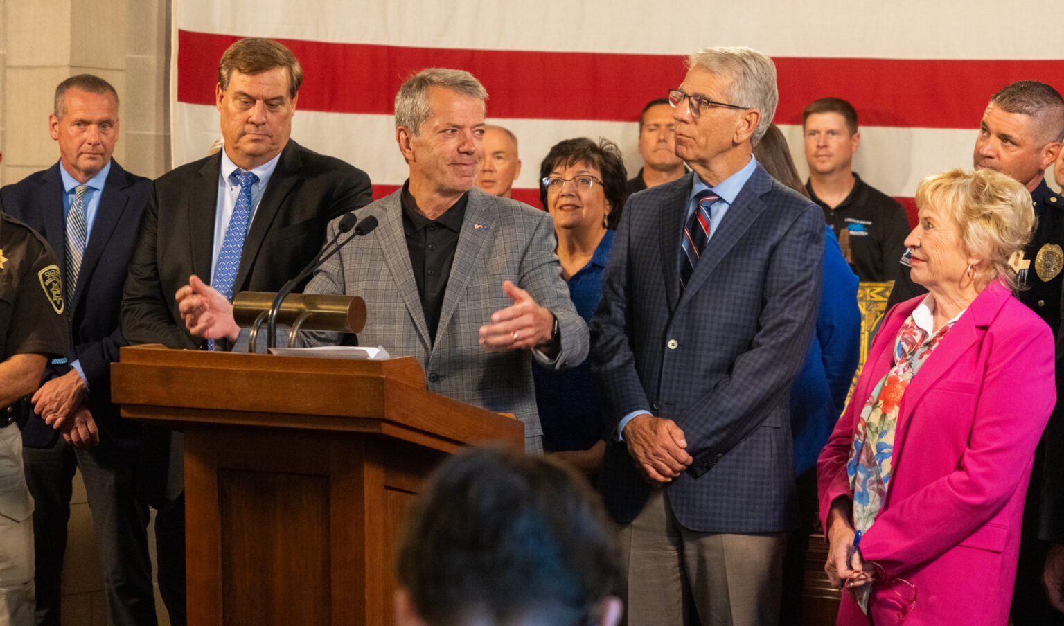 Gov. Jim Pillen (center) hosts a news conference with state senators and law enforcement officers announcing a new property tax exemption related to public safety, Aug. 5, 2024.<br />(Zach Wendling / Nebraska Examiner)