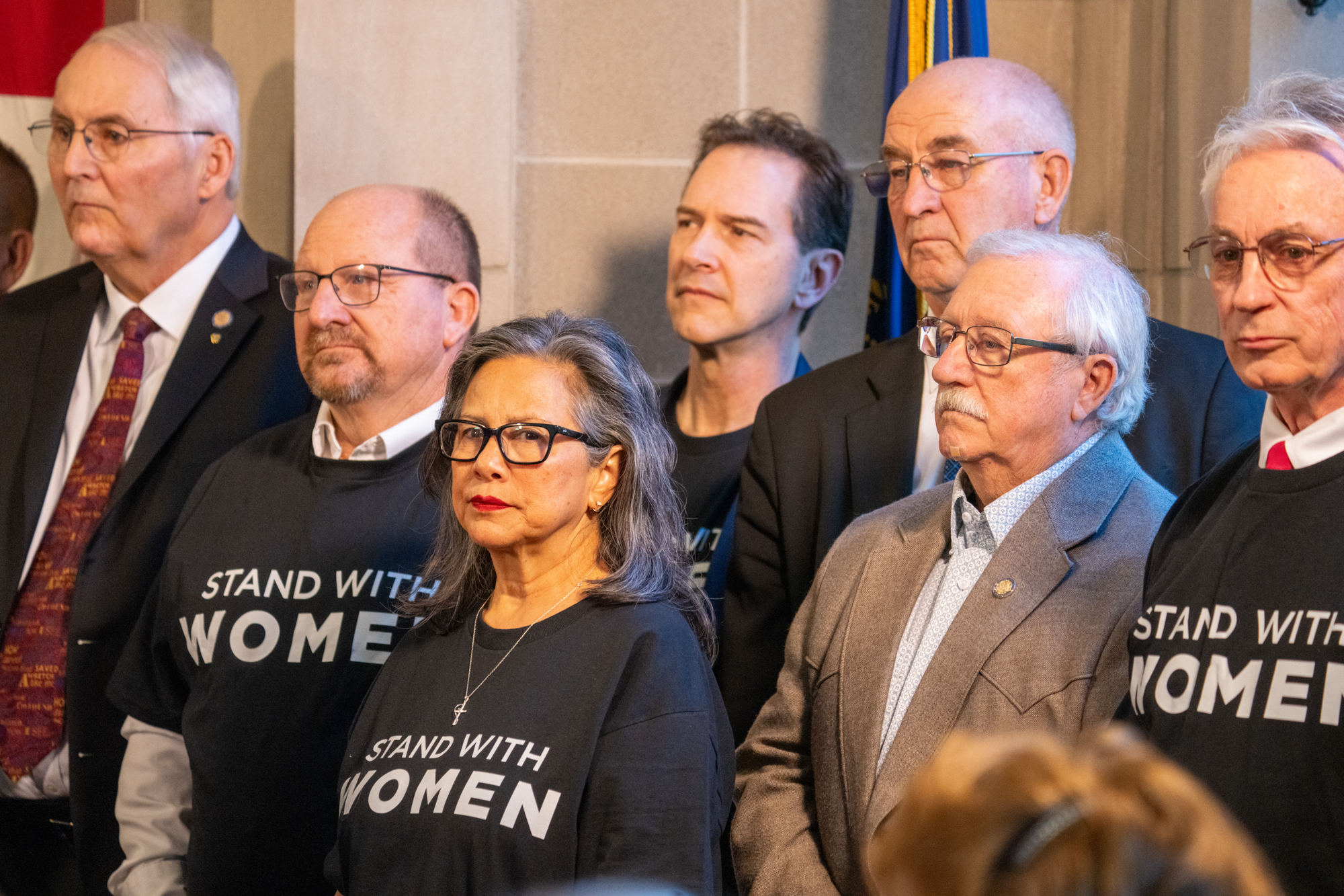 Supporters of State Sen. Kathleen Kauth of Omaha’s Stand With Women Act join at a news conference on Friday, Jan. 10, 2025. In front is State Sen. Rita Sanders of Bellevue, the chair of the likely committee the bill would be referred to for a hearing.<br />(Zach Wendling / Nebraska Examiner)