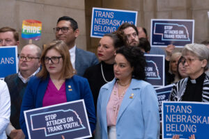 State Sens. Machaela Cavanaugh, in front left, and Jen Day, to Cavanaugh’s left,  rallied in support of trans youth rights in the Nebraska State Capitol earlier this month. (Zach Wendling / Nebraska Examiner)