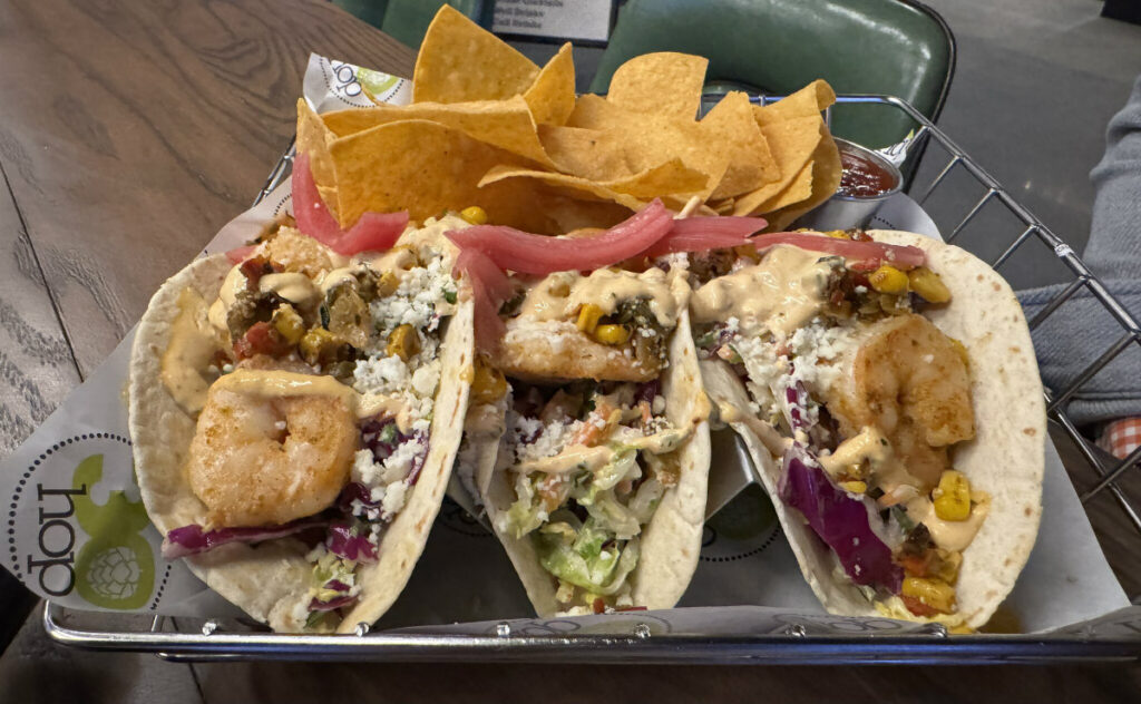 The menu features a variety of tacos, including the grilled shrimp tacos, made with cole slaw, queso fresco cheese, corn salsa, pickled onion, elote crema and cilantro, served in corn tortillas.<br />(Sarah Baker Hansen / Flatwater Free Press)