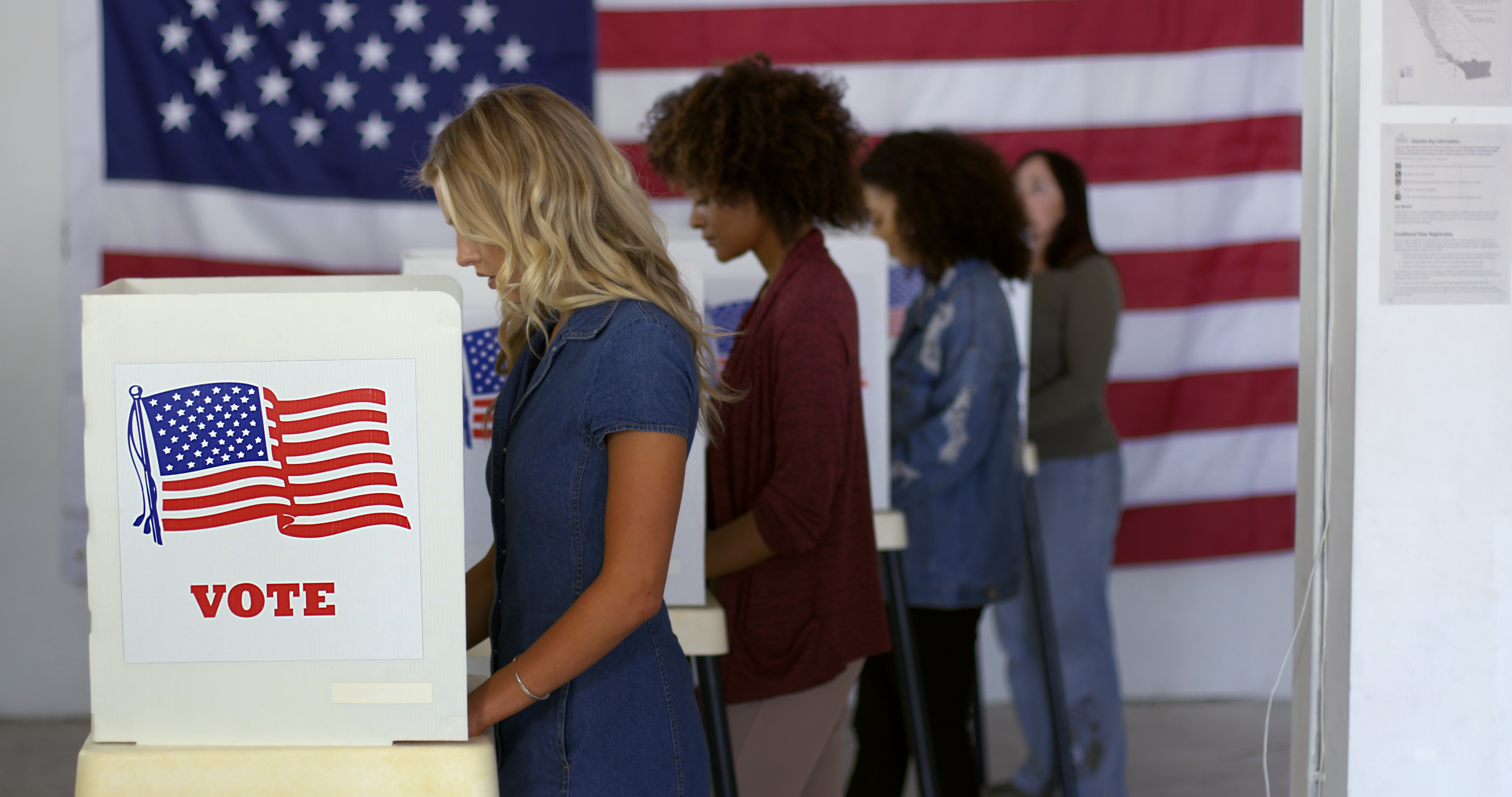 Filling in ballots at a polling station.<br />(Shutterstock)