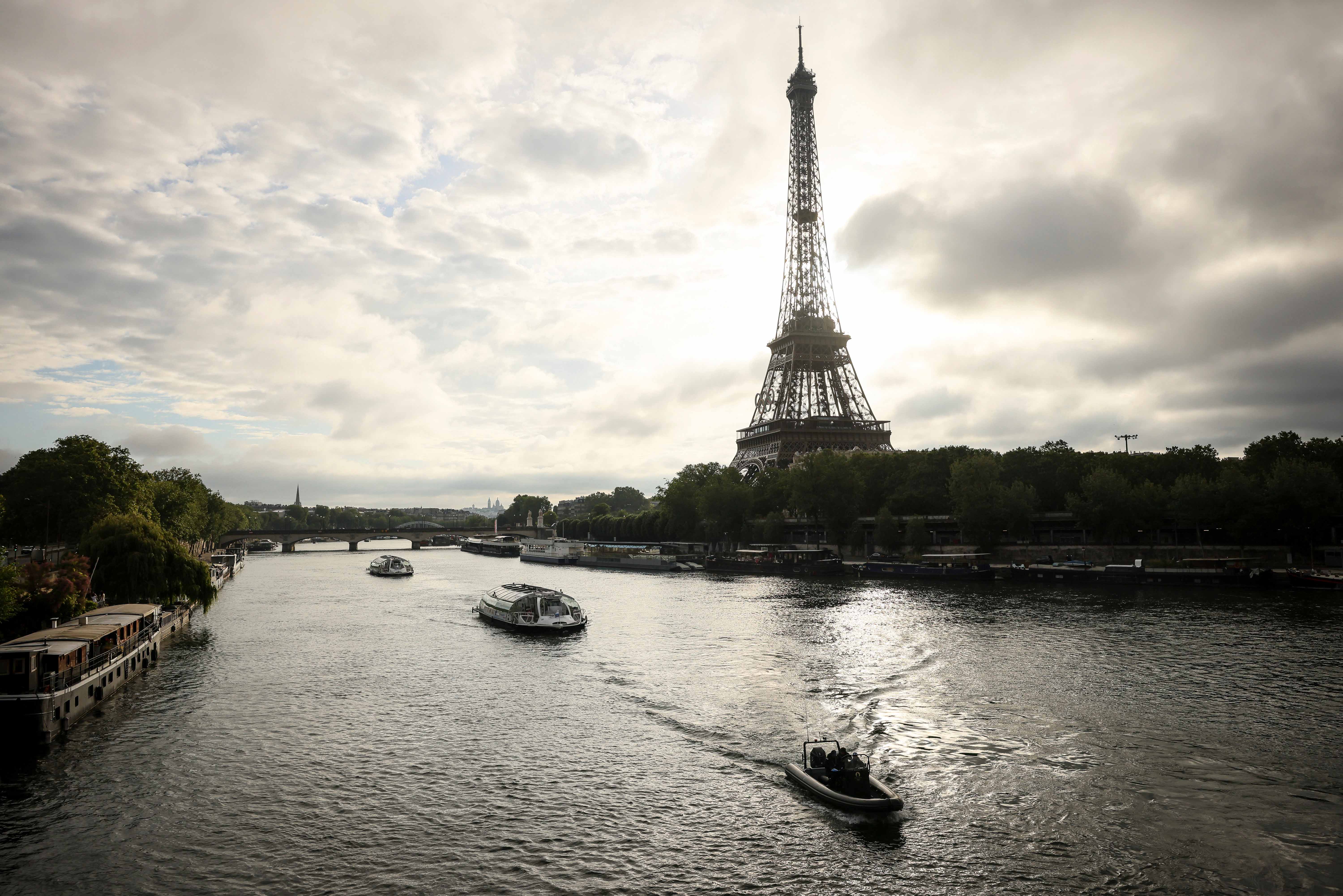 Barges cruise on the Seine River near the Eiffel Tower during a rehearsal for the 2024 Paris Olympic opening ceremony, June. 17, 2024, in Paris.<br />(Thomas Padilla / AP Photo, File)