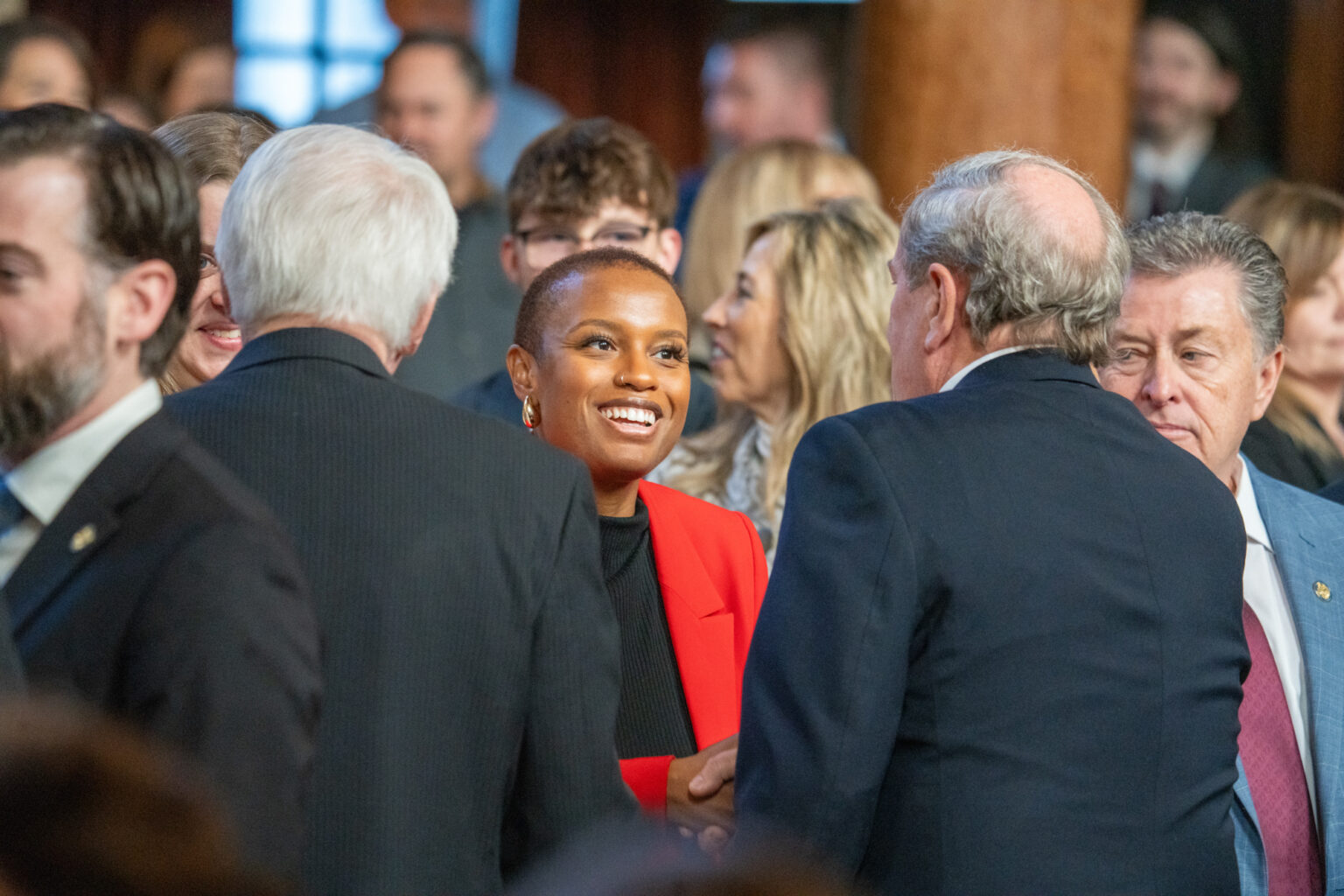 Nebraska lawmakers mingle with newly elected State Sen. Ashlei Spivey of North Omaha. She and others elected in November were sworn into office Wednesday — the first day of the 2025 legislative session.<br />(Zach Wendling / Nebraska Examiner)