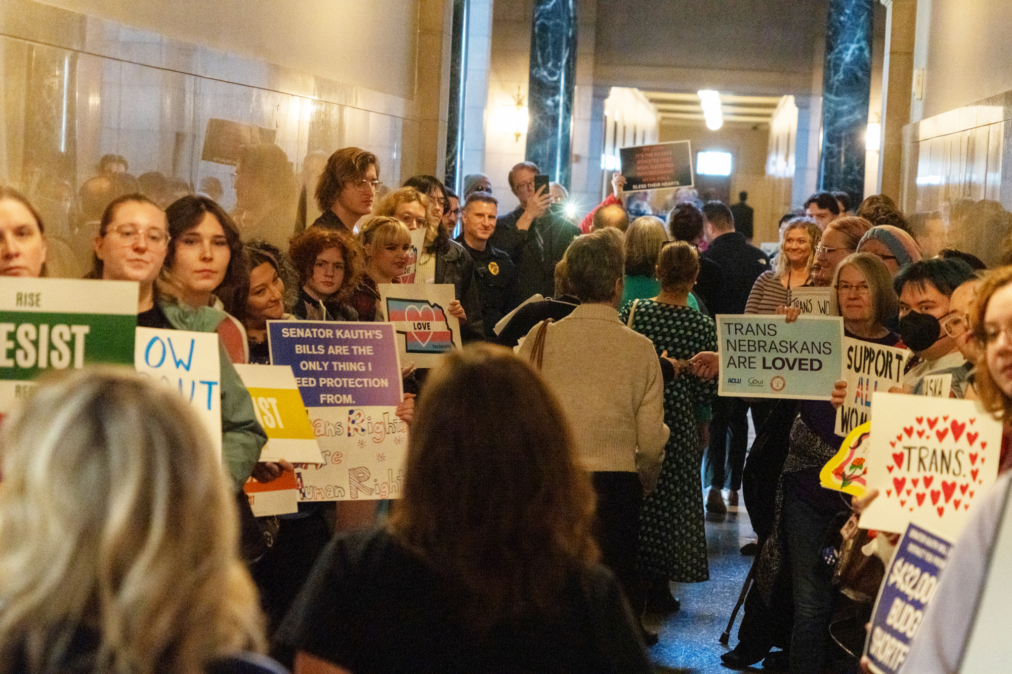 Supporters of transgender Nebraskans lined the hallway outside the governor’s hearing room in the Nebraska State Capitol on Friday, Jan. 10, 2025, to oppose senators and supporters of a newly introduced “Stand With Women Act” by State Sen. Kathleen Kauth of Omaha.<br />(Zach Wendling / Nebraska Examiner)