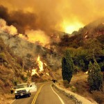 Members of the U.S. Forest Service slowly make their way down Glendora Mountain Road while setting backfires along a containment line to rob the wild fire of fuel Monday, Sept. 23, 2002 in Angeles National Forest north of Glendora, California.
(AP Photo / Ric Francis)
